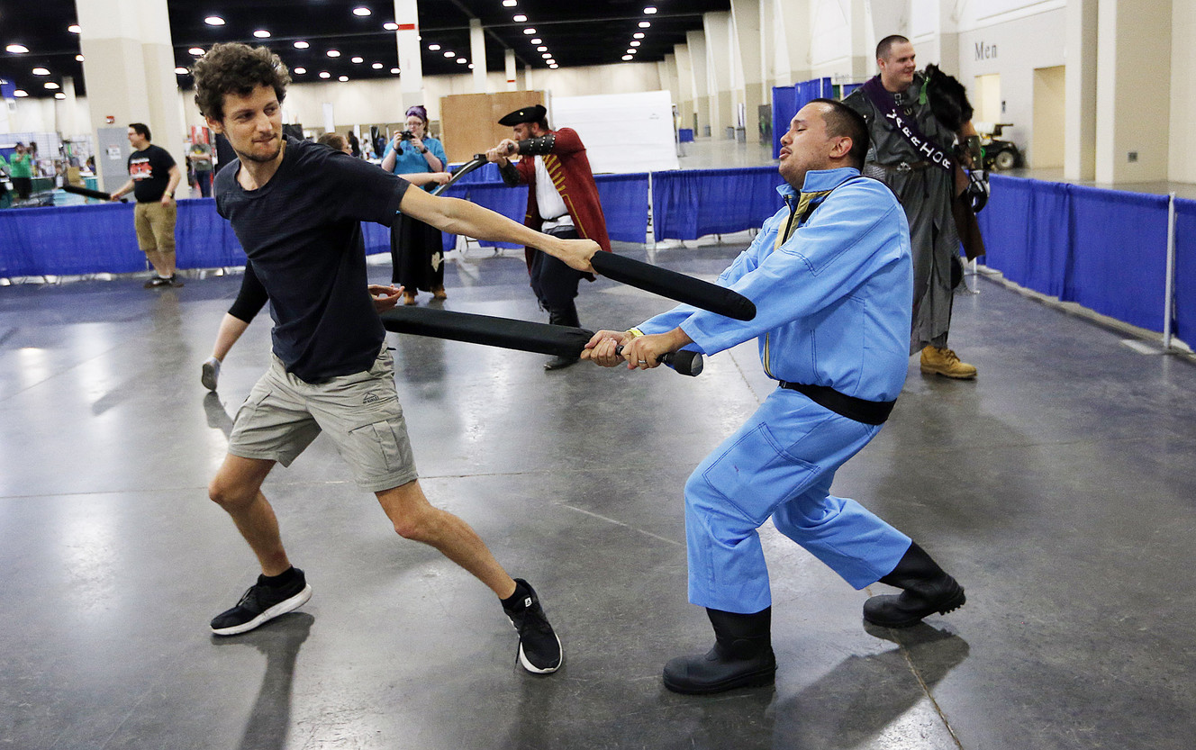 Lucas Fassnacht, left, and Sean Wade participate in live-action role-playing combat during Salt Lake Gaming Con 2017 at the South Towne Expo Center in Sandy on Friday, July 7, 2017. (Photo: Ravell Call, Deseret News)