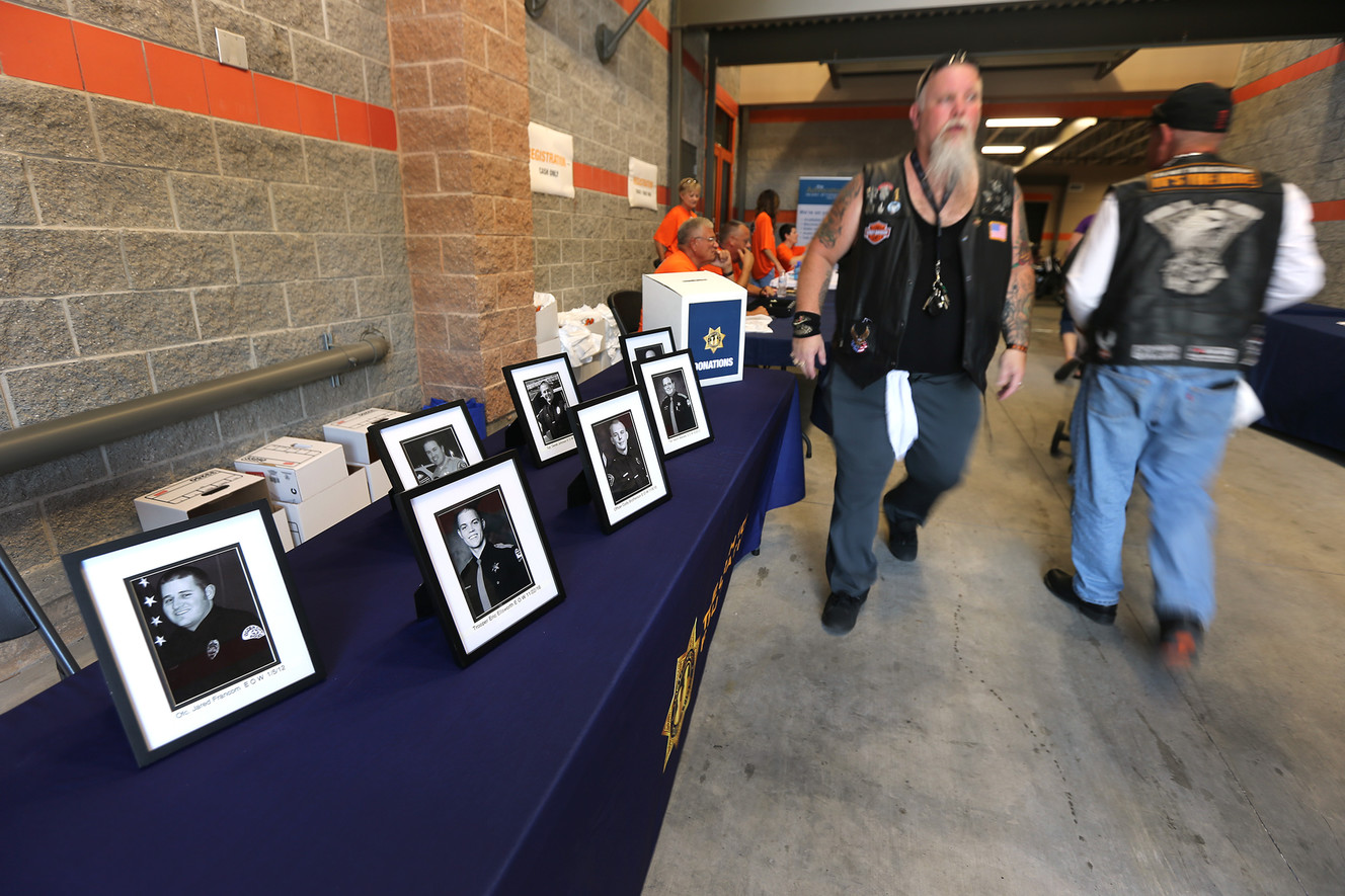 Photos officers who lost their lives in the line of duty are displayed during the UT 1033 Ride in Salt Lake City on Sunday, July 9, 2017. The event is named after the Utah 1033 Foundation, a local nonprofit dedicated to providing immediate financial support to families of Utah’s fallen law enforcement officers. (Photo: Scott G Winterton, Deseret News)
