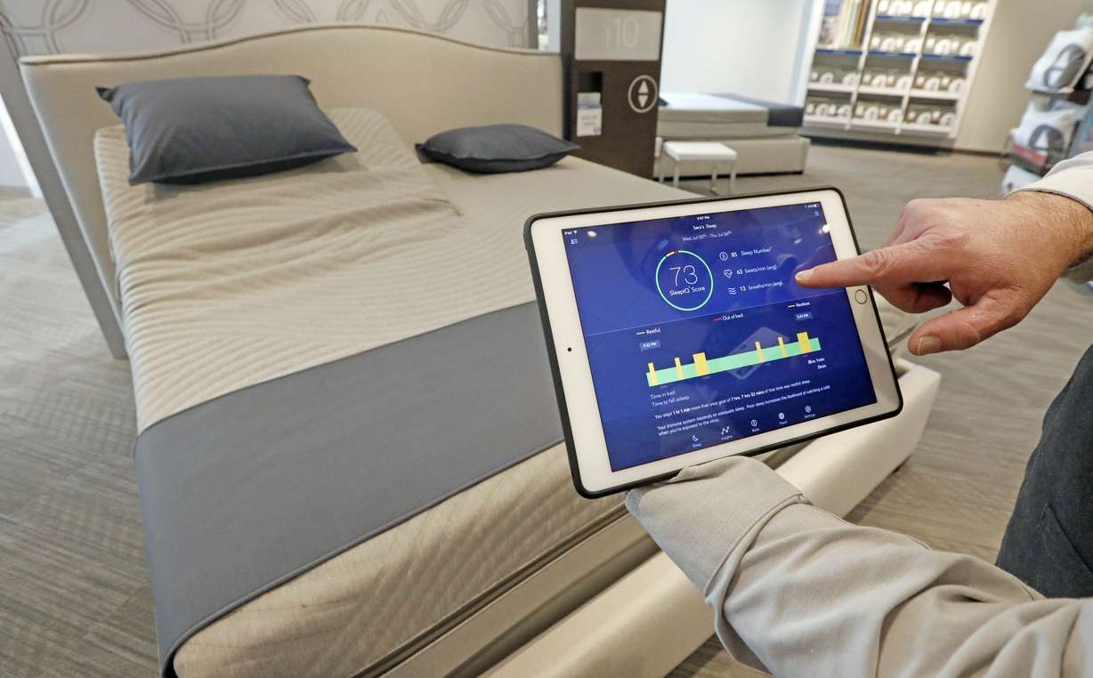 In this Friday, July 7, 2017, photo, Sleep Number store manager Lee Pulliam demonstrates how the company's sleep technology tracks your sleeping patterns, in addition to the other features of the Sleep Number 360 Smart Bed. Photo: AP Photo