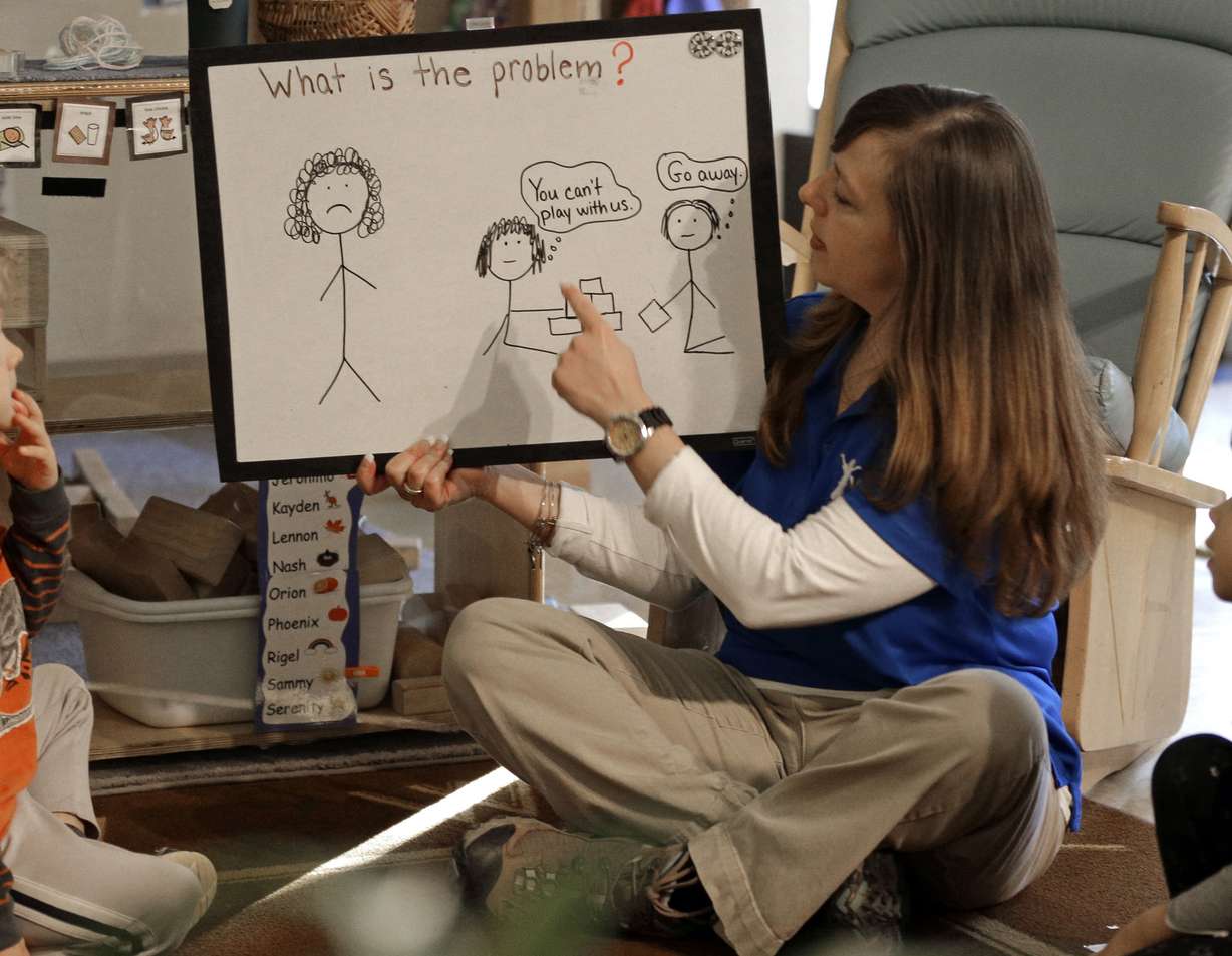 Amy Band, center, teaches children how to handle confrontations at the Verner Center in Asheville, N.C., on Thursday, March 23, 2017. Safe spaces, quiet times and breathing exercises for the preschoolers are designed to help kids cope with intense stress so they can learn. (AP Photo/Chuck Burton)