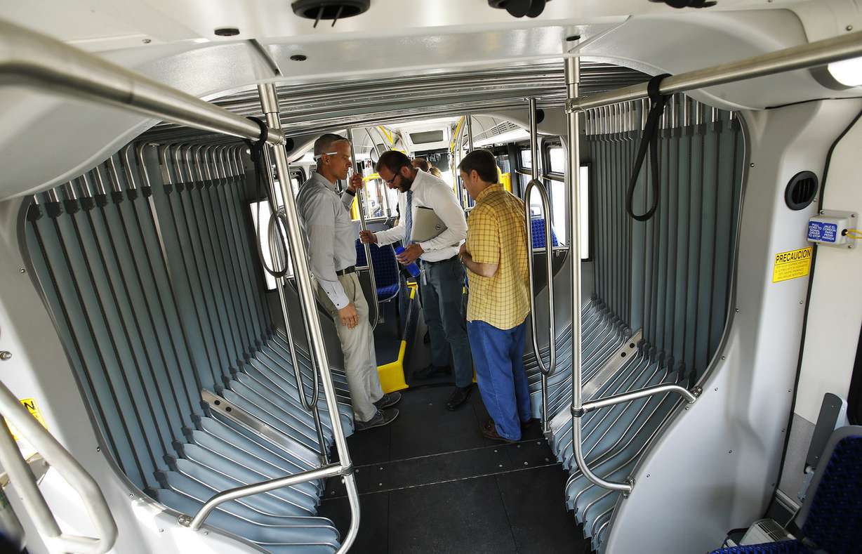 Utah Transit Authority employees look over the New Flyer Xcelsior 60-foot articulated bus in Salt Lake City on Friday, July 14, 2017. The bus is powered by a clean-air diesel-electric hybrid motor and can hold up to 80 passengers. (Photo: Jeffrey D. Allred, Deseret News)