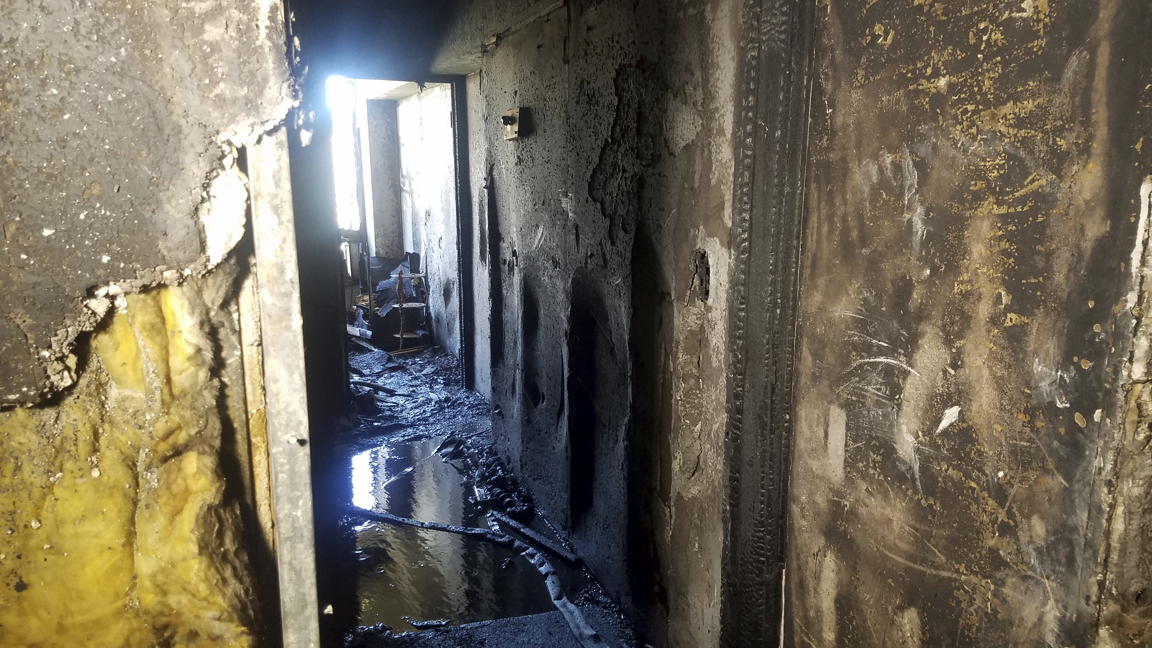 The Latest: Victim's kin: High-rise should've had sprinklers