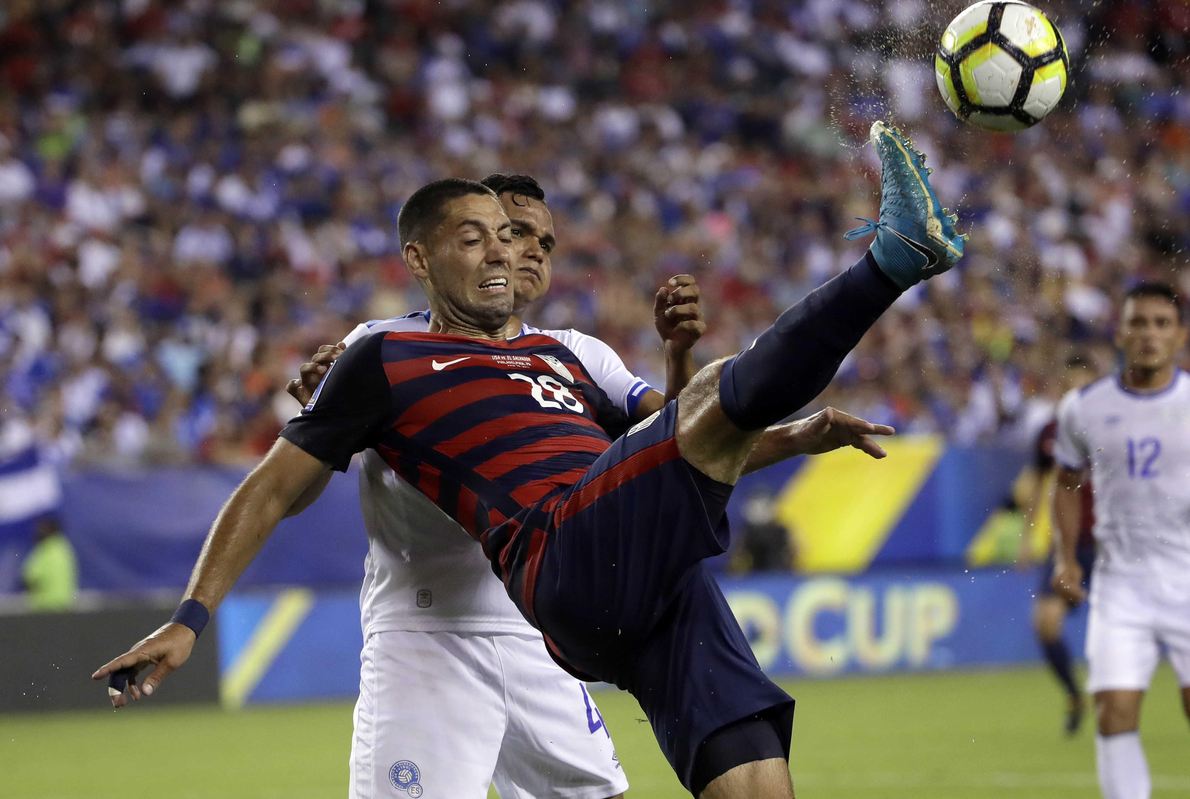 US survives biting incident, beats El Salvador 2-0, advances
