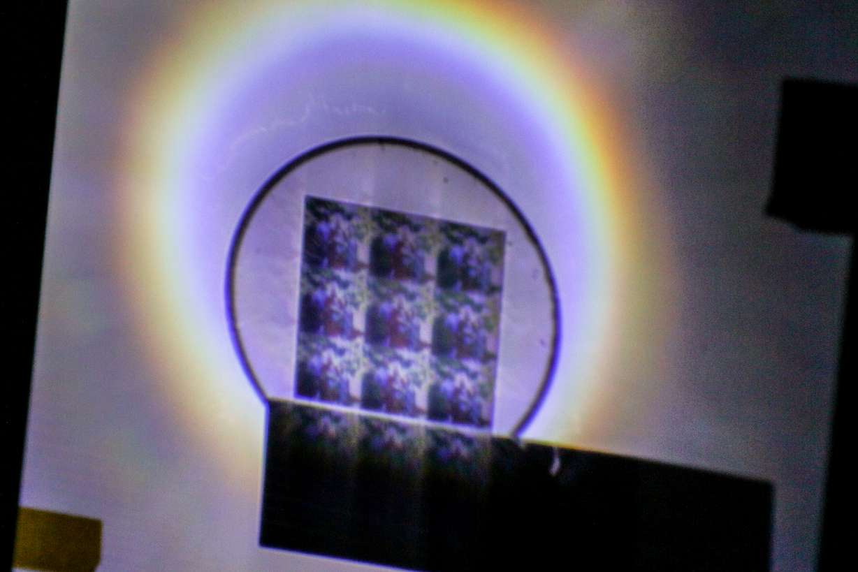 Rajesh Menon shows off a new 2D hologram that can be displayed with just a flashlight. Photo: Dan Hixon