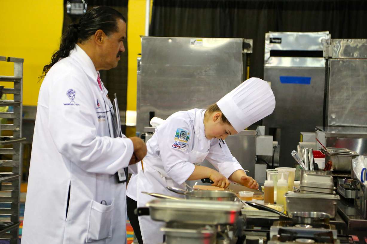 A judge watches Utah Valley University culinary student Madeline Black during the American Culinary Federation Cook. Craft. Create. national convention on July 8-13 in Orlando, Florida. Black was named the National Student Chef of the Year after making a winning dish including truffle-scented duck roulade finished in duck fat, with Utah honey lacquered duck thigh-riblet. (Photo: Jim McCulloch, Utah Valley University Culinary Arts Institute)