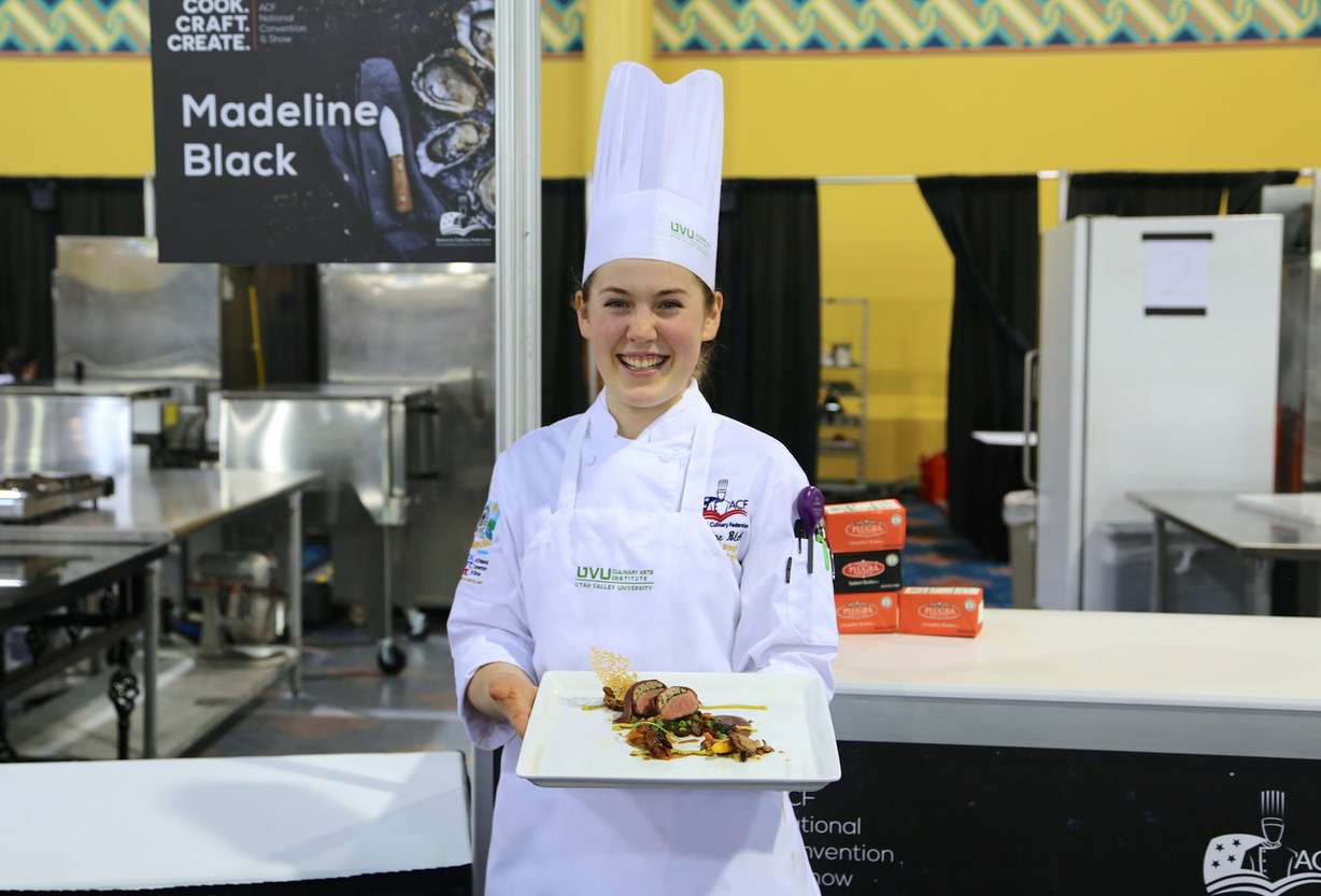 Utah Valley University culinary student Madeline Black displays her award-winning dish of duck roulade during the American Culinary Federation Cook. Craft. Create. national convention on July 8-13 in Orlando, Florida. Black was named the National Student Chef of the Year after making truffle-scented duck roulade finished in duck fat, with Utah honey lacquered duck thigh-riblet. (Photo: Jim McCulloch, Utah Valley University Culinary Arts Institute)