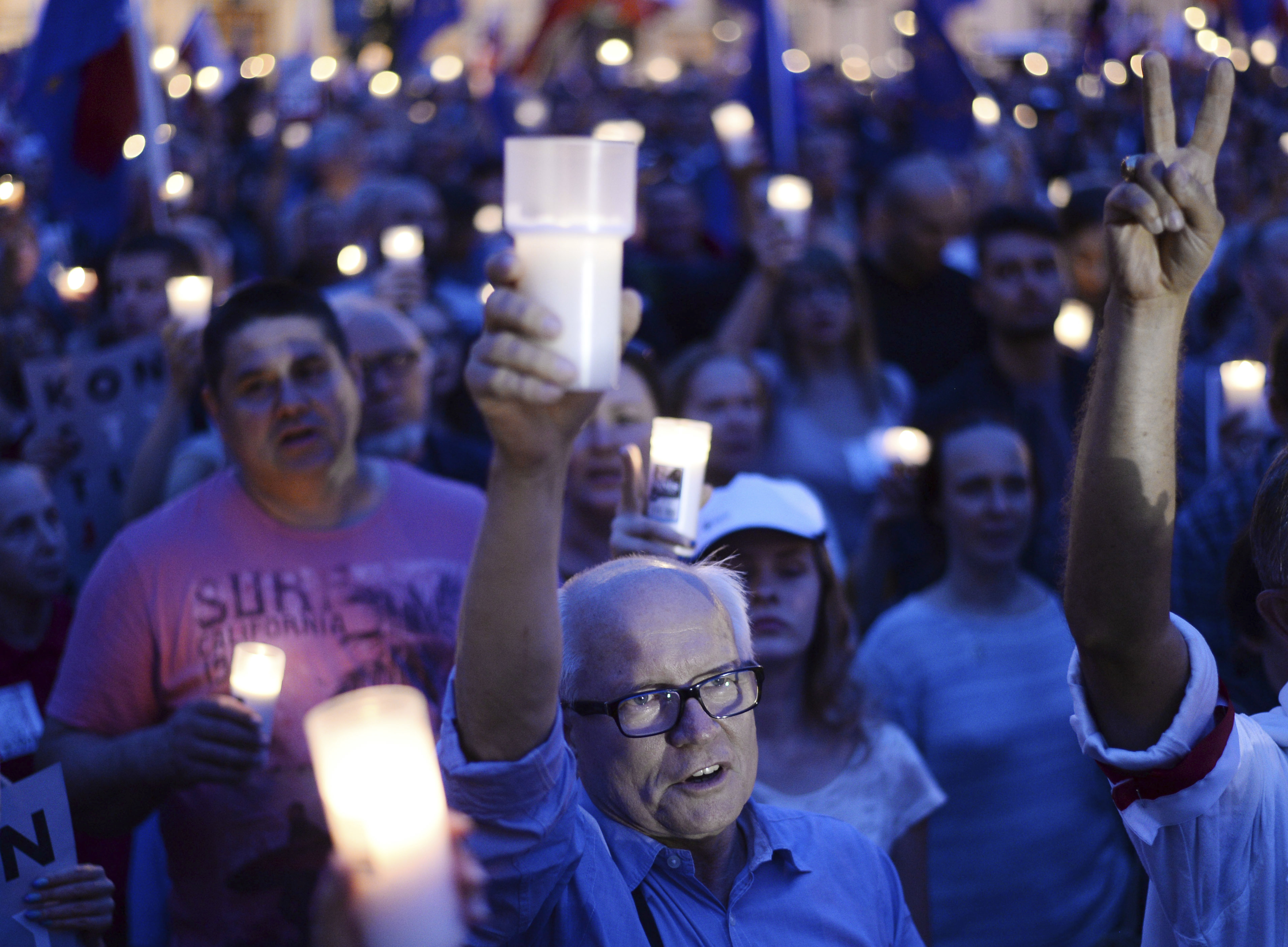 Amid protests, Polish leader puts brakes on judicial shakeup