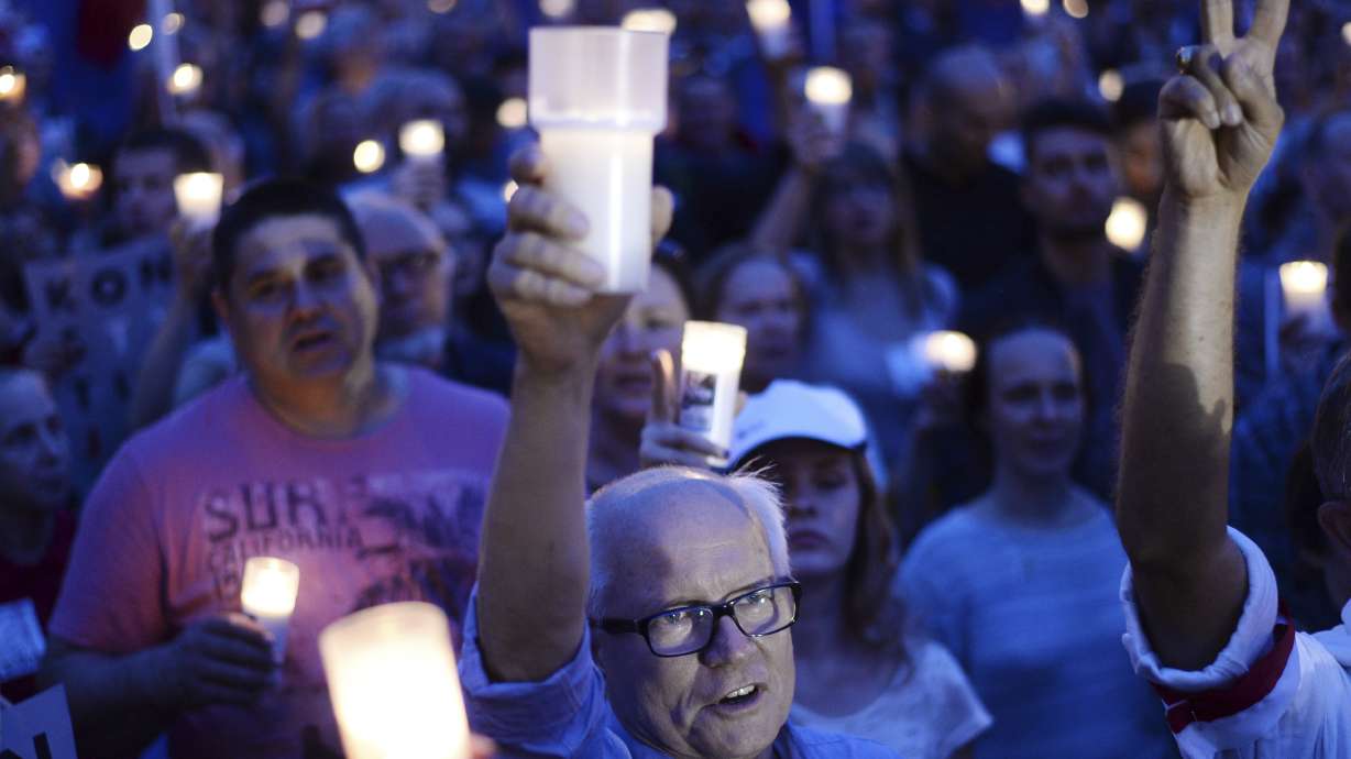 The Latest: Polish PM criticizes president for bill vetoes