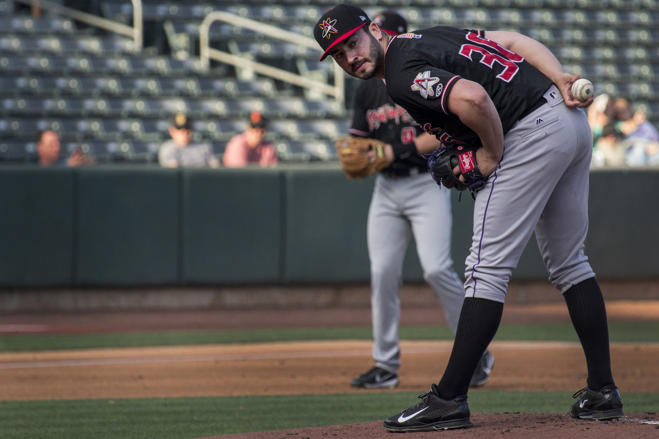 Albuquerque Isotopes pitcher Chad Bettis stares down a runner at first base during a game against the Salt Lake Bees on Sunday, July 23, 2017. Bettis beat cancer twice and is working to make his way back to the Colorado Rockies this season. (Photo: Carter Williams, KSL.com)