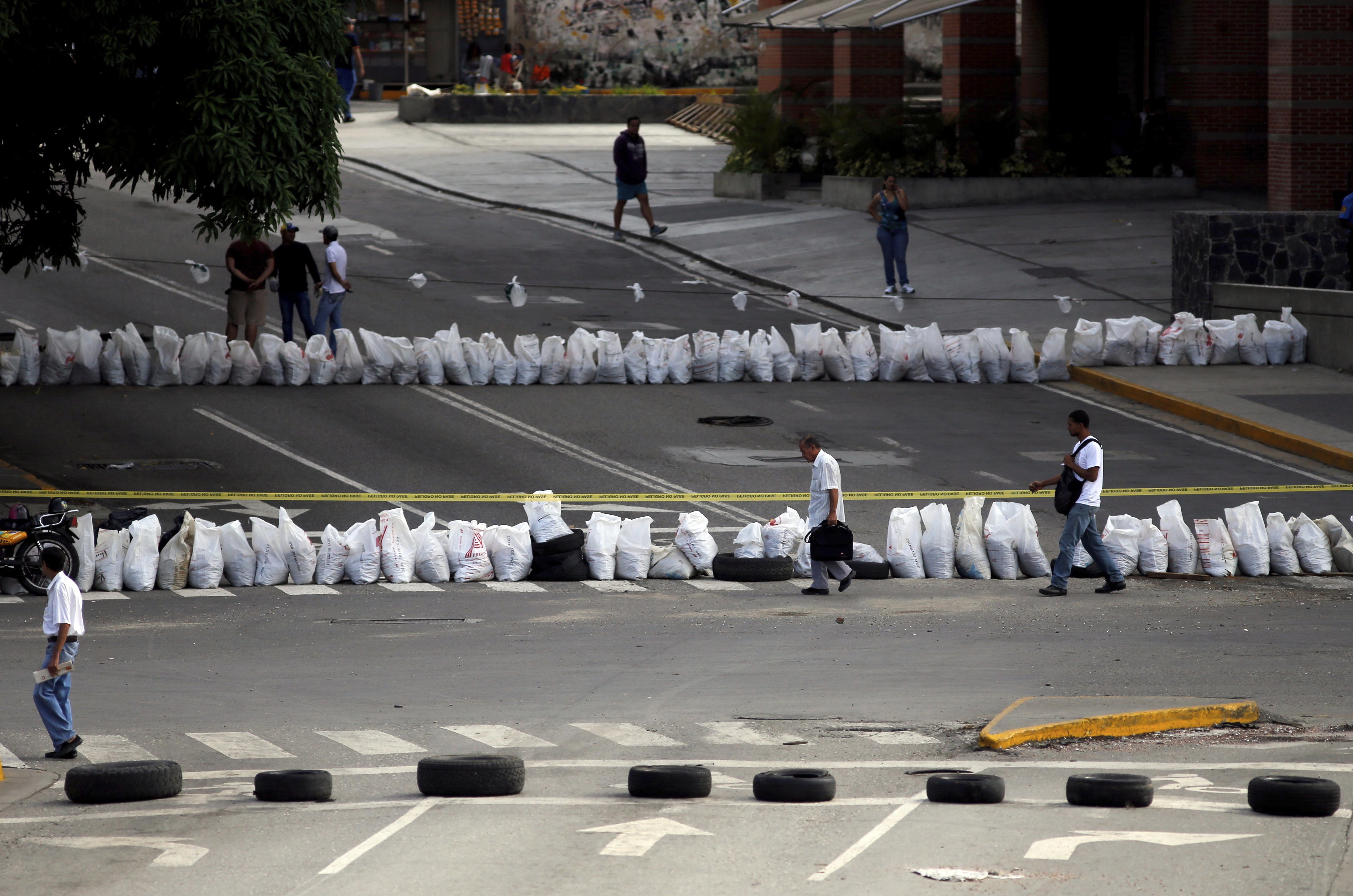 Venezuela leader's foes levy new sanctions and fresh strike