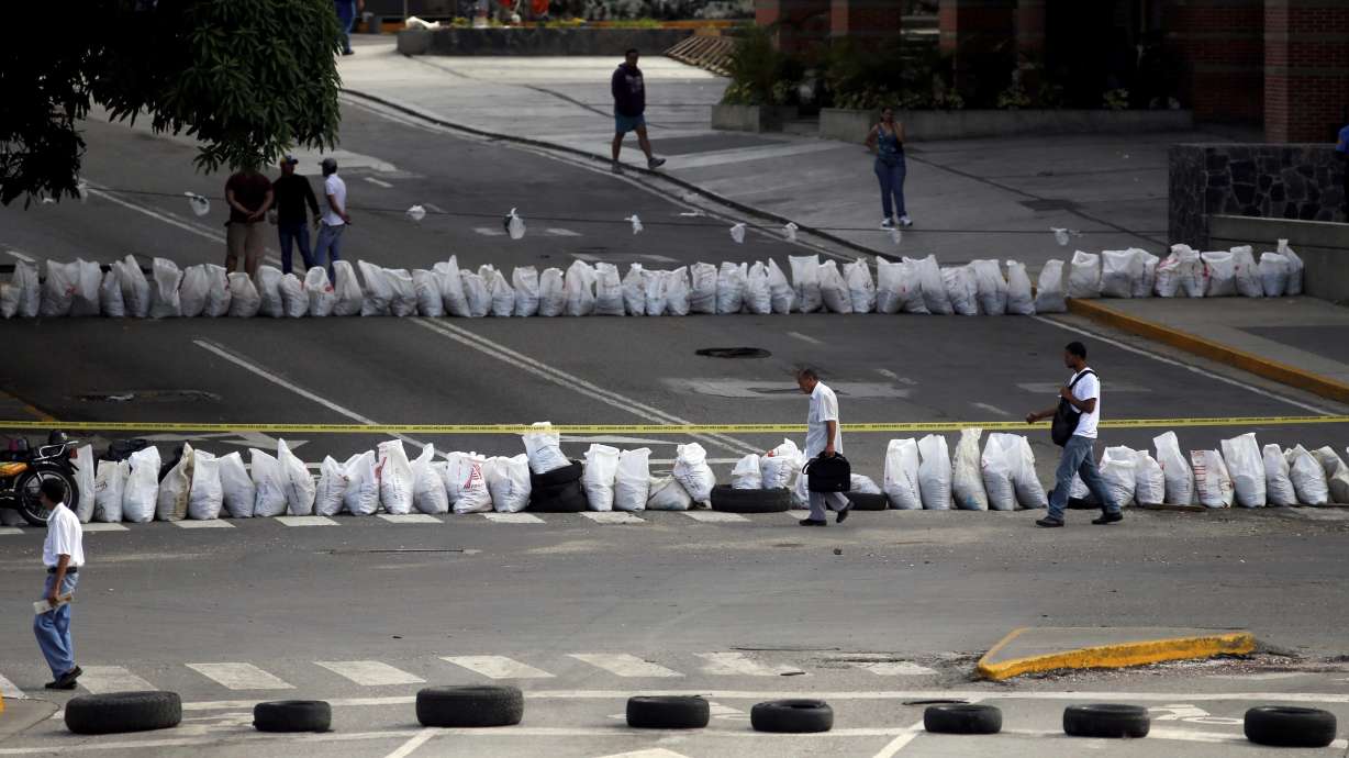 Venezuela leader's foes levy new sanctions and fresh strike