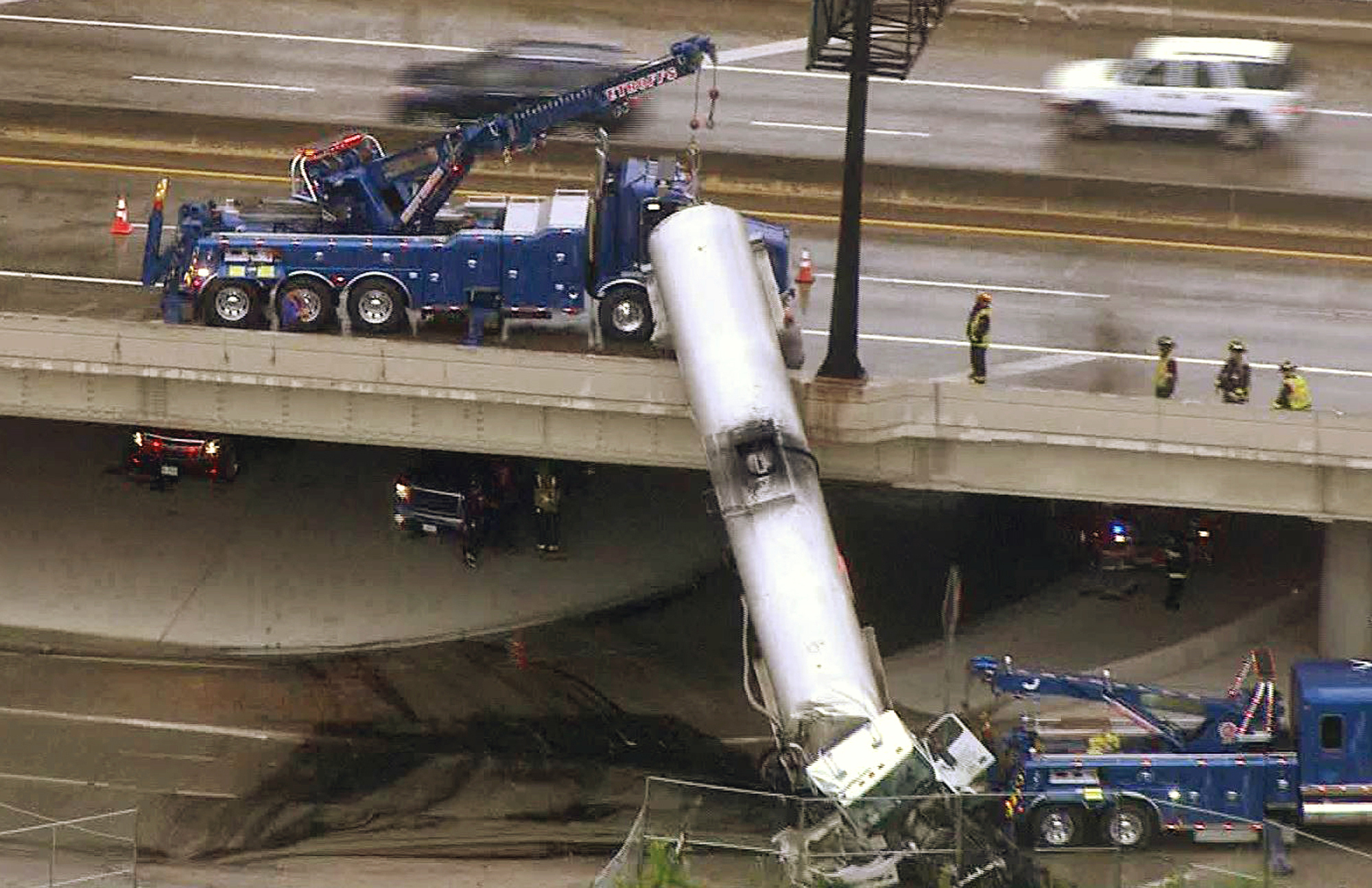 Tanker left dangling from overpass after interstate crash