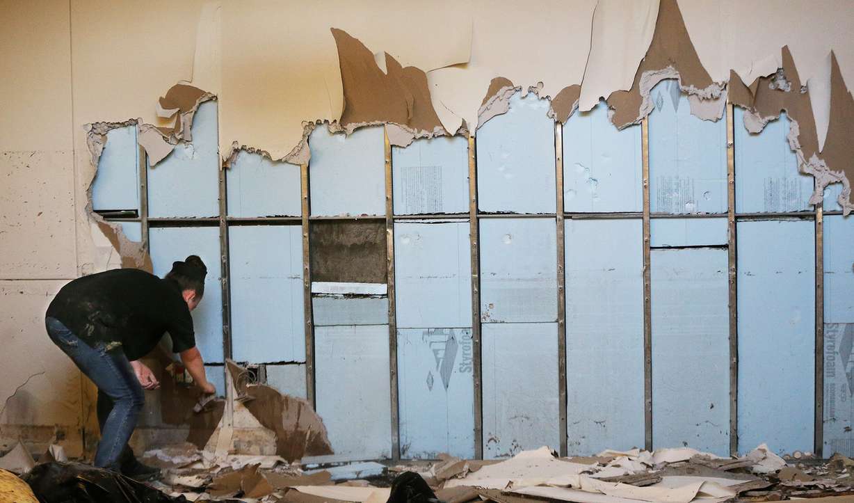 Vanessa Kinder removes dry wall during clean up after flooding at Sprague Library in Sugar House on Thursday, July 27, 2017. (Photo: Jeffrey D. Allred, Deseret News)