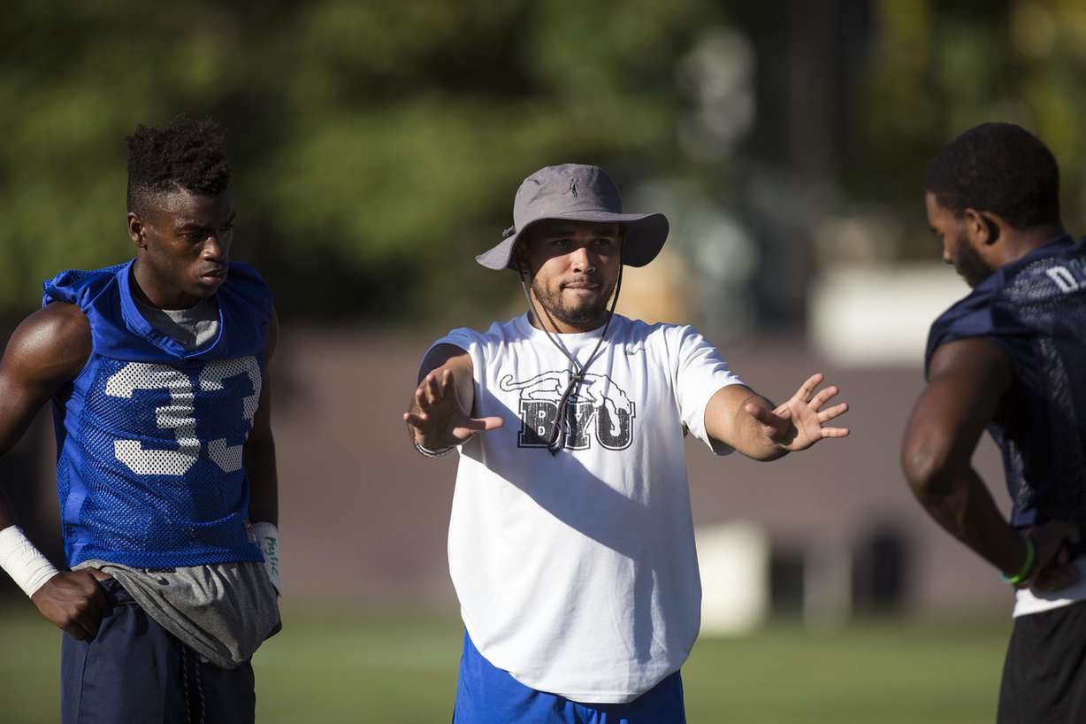 Freshman D'Angelo Gunter, left, listens to the direction of Student Assistant Trevor Brent with Akile Davis at the BYU Cougars' first practice of the season in Provo on Thursday, July 27, 2017. (Photo: Kelsey Brunner, Deseret News)