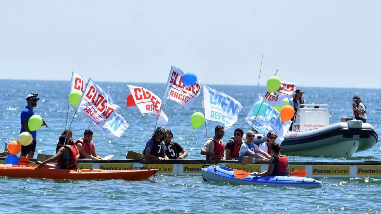 The Latest: Flotilla departs to counter anti-migrant boat