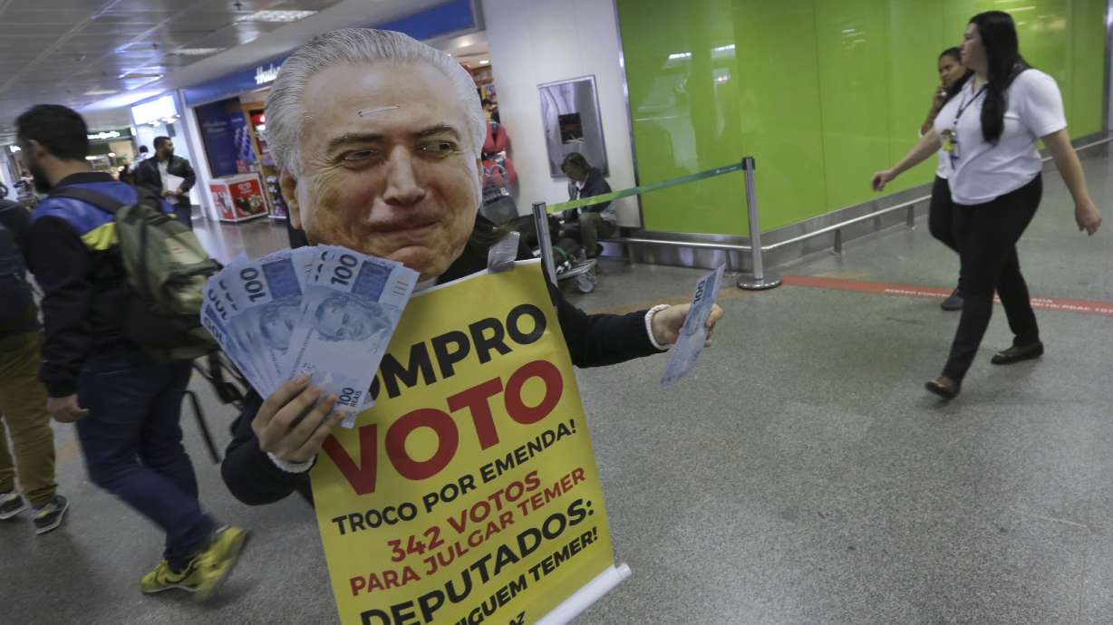 Brazil embattled president survives vote on bribery charge