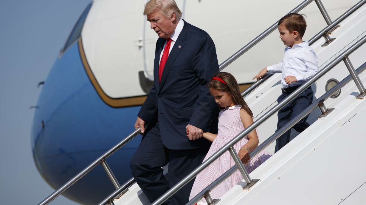 The Latest: Trump defends his working vacation