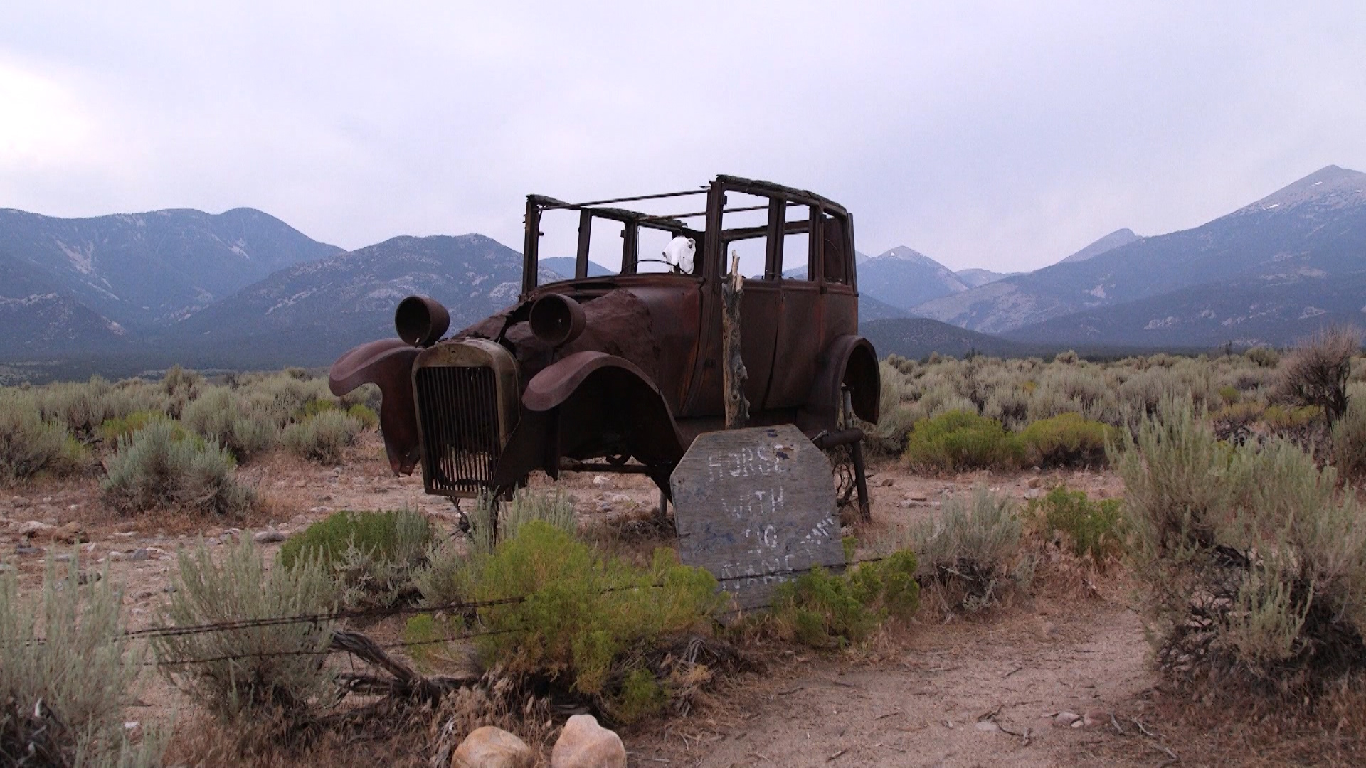 A rusty wreck of a car sits in the sagebrush with a weathered old skull from a horse in a position that makes it look like a horse is driving. Labeled "The Horse With No Name," the artwork seems to be open to any interpretation. (Photo: John Hollenhorst, KSL TV)