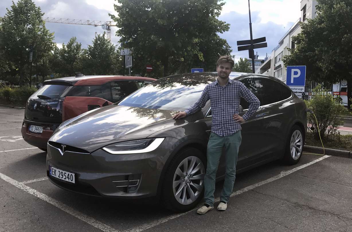 In this photo provided by Nils Henningstad, Henningstad poses next to his Tesla Model X while charging the electric car at a public charging station, Thursday, July 13, 2017, in Lillestrom, just outside Oslo, Norway. Photo: AP Photo