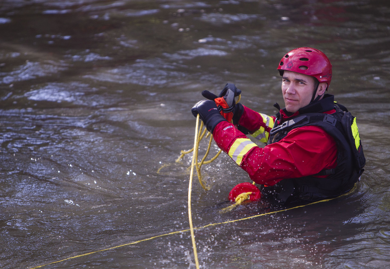 Firefighter Brian Leftwich pulls rope while simulating a victim with his foot stuck during the Salt Lake City Fire Department's intensive training for swift water rescue in Salt Lake City on Saturday, Aug. 12, 2017. (Photo: Kelsey Brunner, Deseret News)