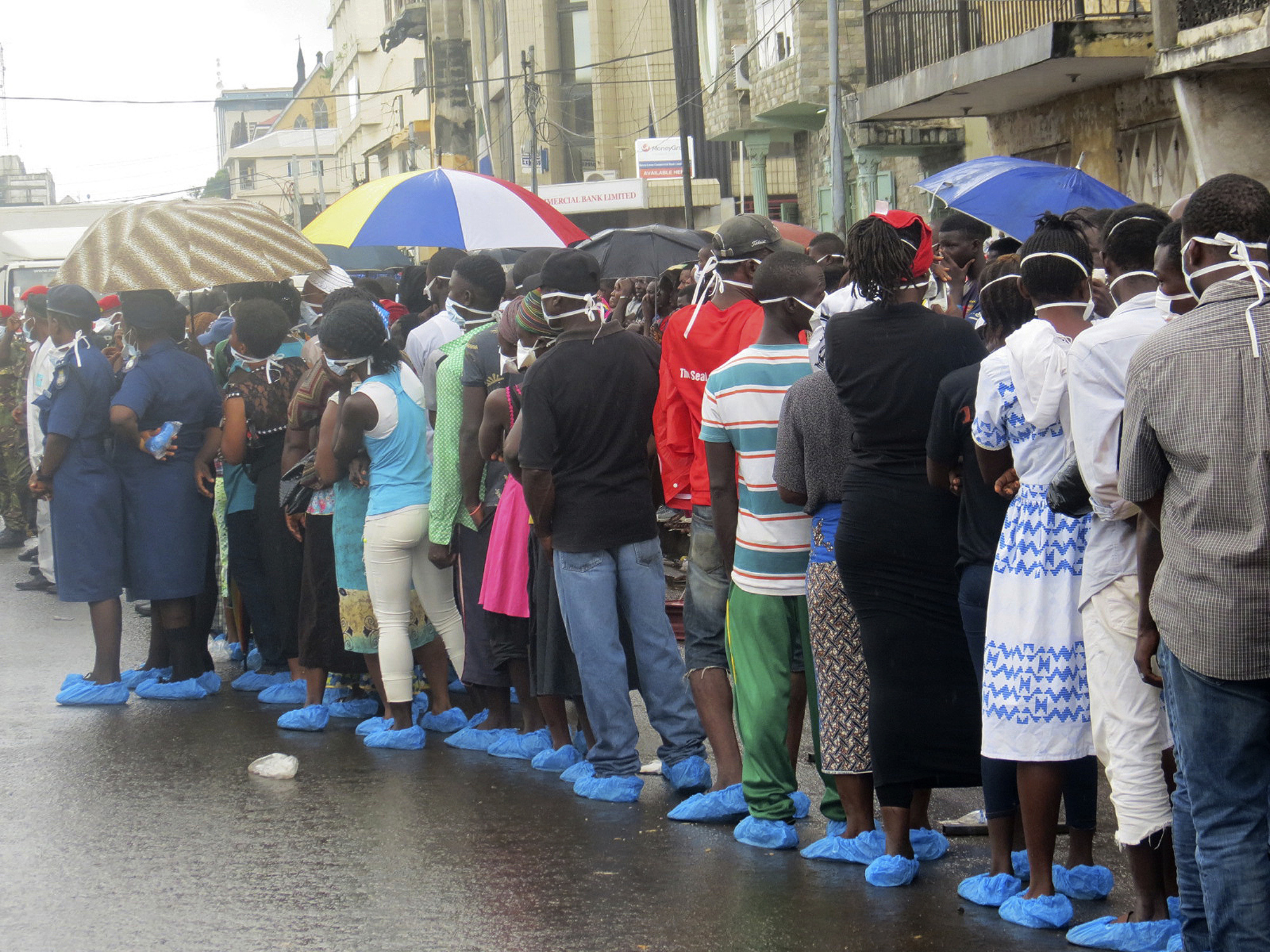 Families wait in rain to ID lost loved ones in Sierra Leone