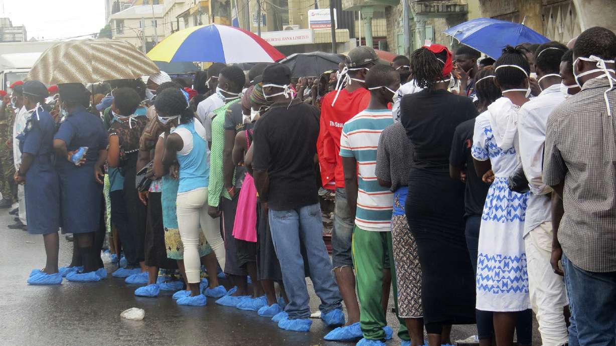 Families wait in rain to ID lost loved ones in Sierra Leone