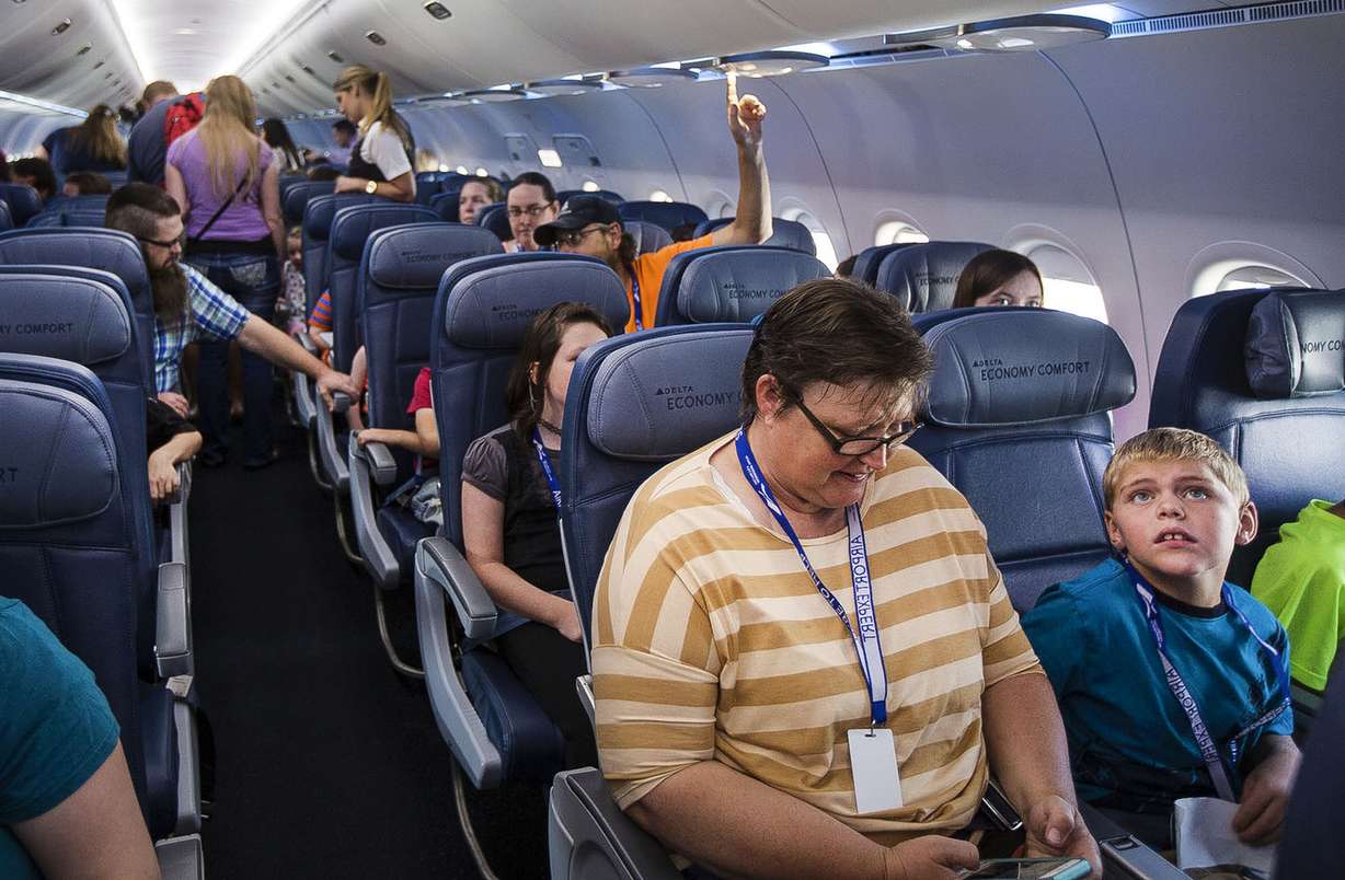 Families take their seats and explore the airplane during the Taking Flight for Autism event at the Salt Lake City International Airport in Salt Lake City on Thursday, Aug. 17, 2017. (Photo: Kelsey Brunner, Deseret News)