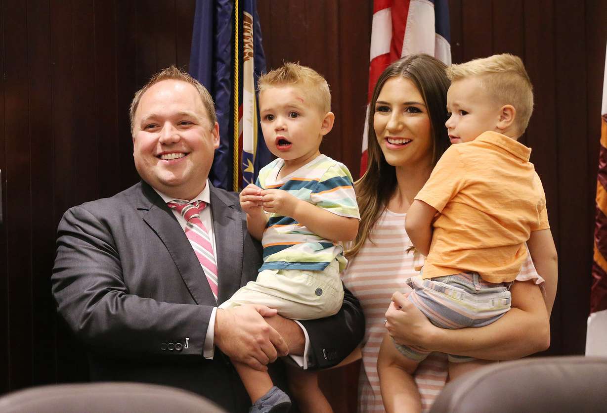 Adam Gardiner, wife Katie and sons Mason and Jaxon pose for a photo after he was sworn in as the new Salt Lake County recorder during a special meeting of the County Council in Salt Lake City on Friday, Aug. 18, 2017. (Photo: Jeffrey D. Allred, Deseret News)