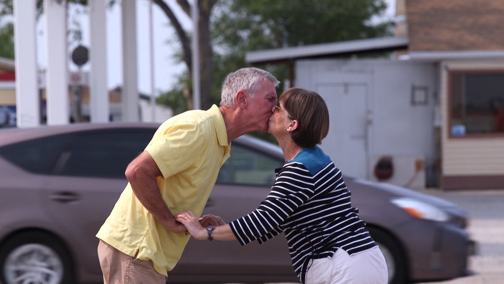 Sandy residents Ellen and Clark Wallace stopped for gas at the Border Inn and then took a moment to smooch next to the highway, their lips meeting somewhere around the exact boundary between two states. (KSL TV)
