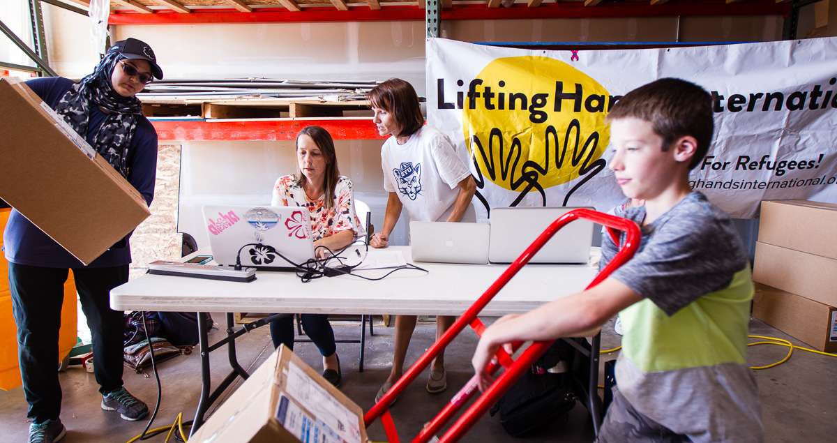 Mariam Kergaye, left, Lacy Richards, Traci Parson and Luke Nelson ready supplies for Jordan by preparing Customs forms in Riverdale on Saturday, Aug. 19, 2017. (Photo: Adam Fondren, Deseret News)