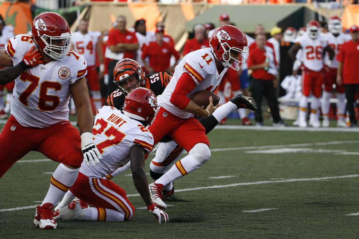 Kansas City Chiefs quarterback Alex Smith (11) runs the ball against Cincinnati Bengals inside linebacker Nick Vigil (59) in the first half of an NFL preseason football game, Saturday, Aug. 19, 2017, in Cincinnati. (AP Photo/Frank Victores)