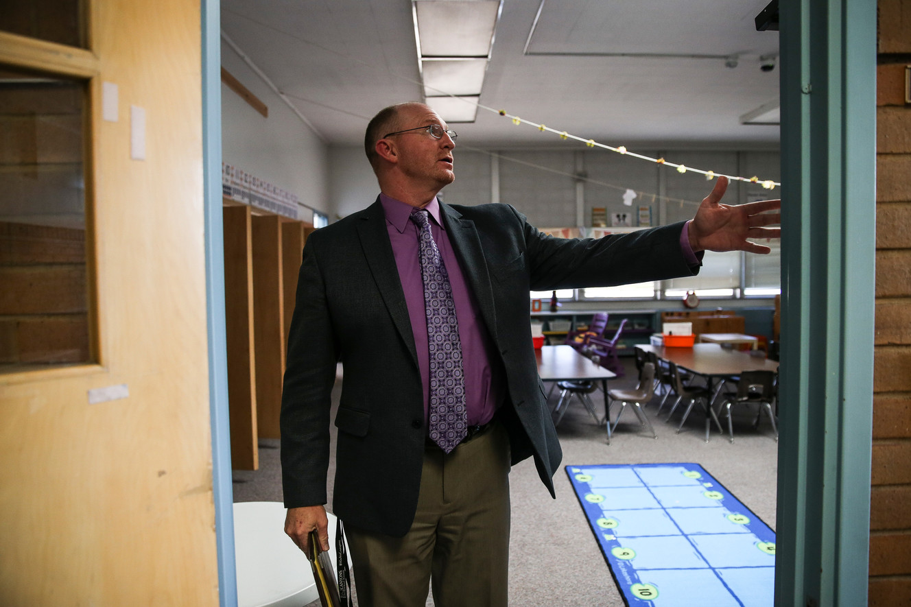 Jeff Haney, chief communications officer for Canyons School District, shows off outdated features at Midvalley Elementary in Midvale on Tuesday, Aug. 22, 2017. The school's masonry and unreinforced concrete interior walls are not seismically safe, make it difficult to run wiring and make temperature regulation difficult. (Photo: Spenser Heaps, Deseret News)