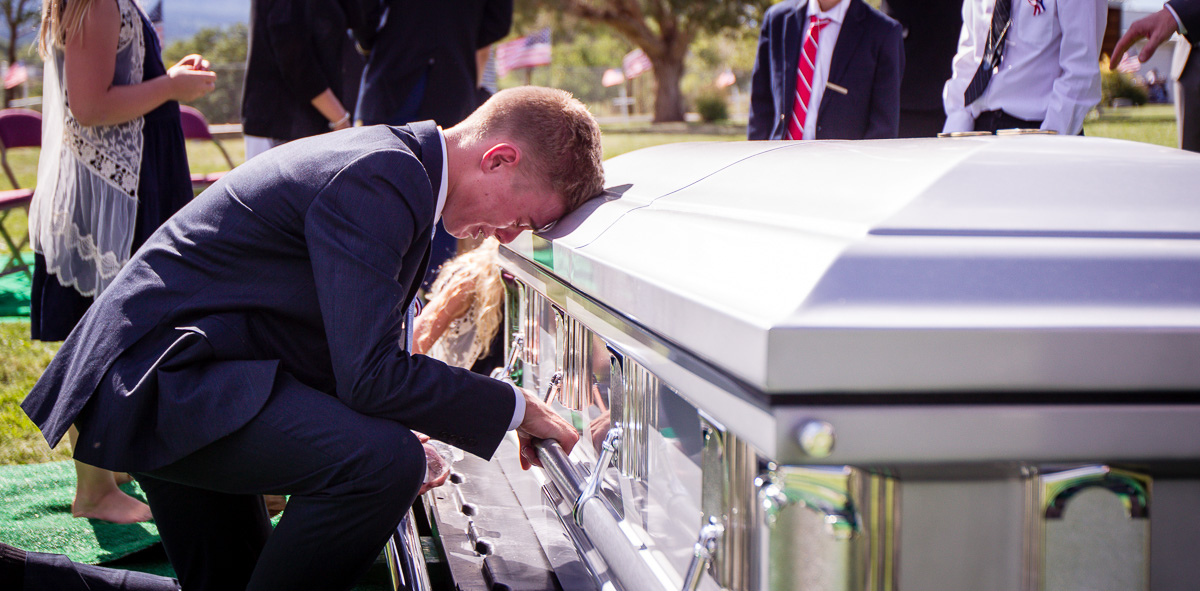A member of Staff Sgt. Aaron Butler's family pauses at his casket during funeral services in Monticello on Saturday, Aug. 26, 2017. Butler, 27, a Green Beret assigned to the Utah National Guard's 19th Special Forces was killed in action in Nangarhar Province in Afghanistan on Aug. 16. (Photo: Adam Fondren, Deseret News)