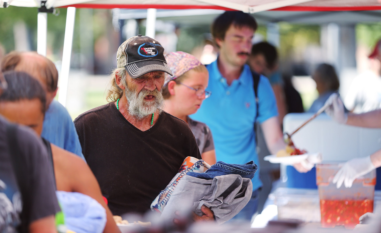 Food is handed out as homeless residents are treated to a picnic lunch in Pioneer Park in Salt Lake City on Sunday, Aug. 27, 2017. Participants also received a new blanket and listened to live music. (Photo: Jeffrey D. Allred, Deseret News)