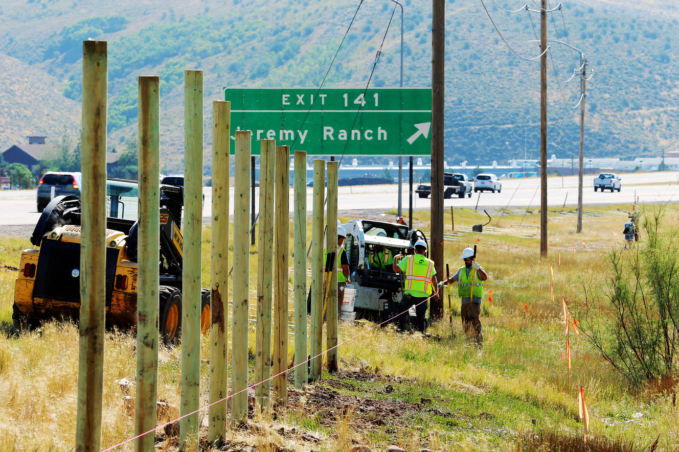 Workers from Vinyl Industries work as Utah Department of Transportation puts up wildlife fencing along the eastbound lanes of I-80 near Jeremy Ranch on Monday, Aug. 28, 2017. (Photo: Scott G Winterton, Deseret News)