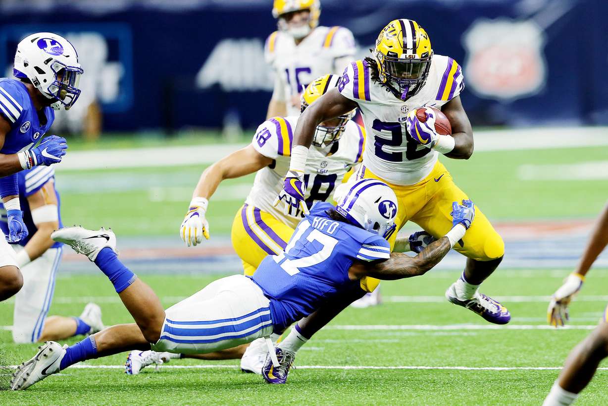 BYU defensive back Marvin Hifo (17) tries to bring down LSU running back Darrel Williams (28) as BYU and LSU play in the Mercedes-Benz Superdome in New Orleans on Saturday, Sept. 2, 2017. (Photo: Scott G Winterton, Deseret News)
