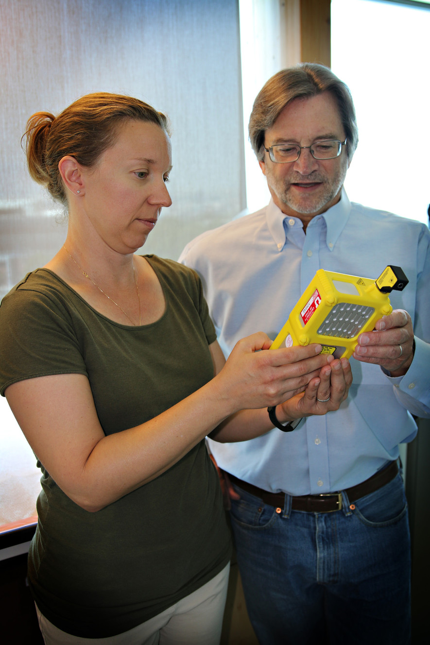 Marc Porter, a University of Utah chemical engineering and chemistry professor, and Jennifer Granger, an associate researcher at the Nano Institute of Utah, examine a portable spectrometer that they say could one day help rapidly flag patients' signs of liver cancer, in conjunction with a small and inexpensive test kit the researchers are developing. (Photo: University of Utah College of Engineering)