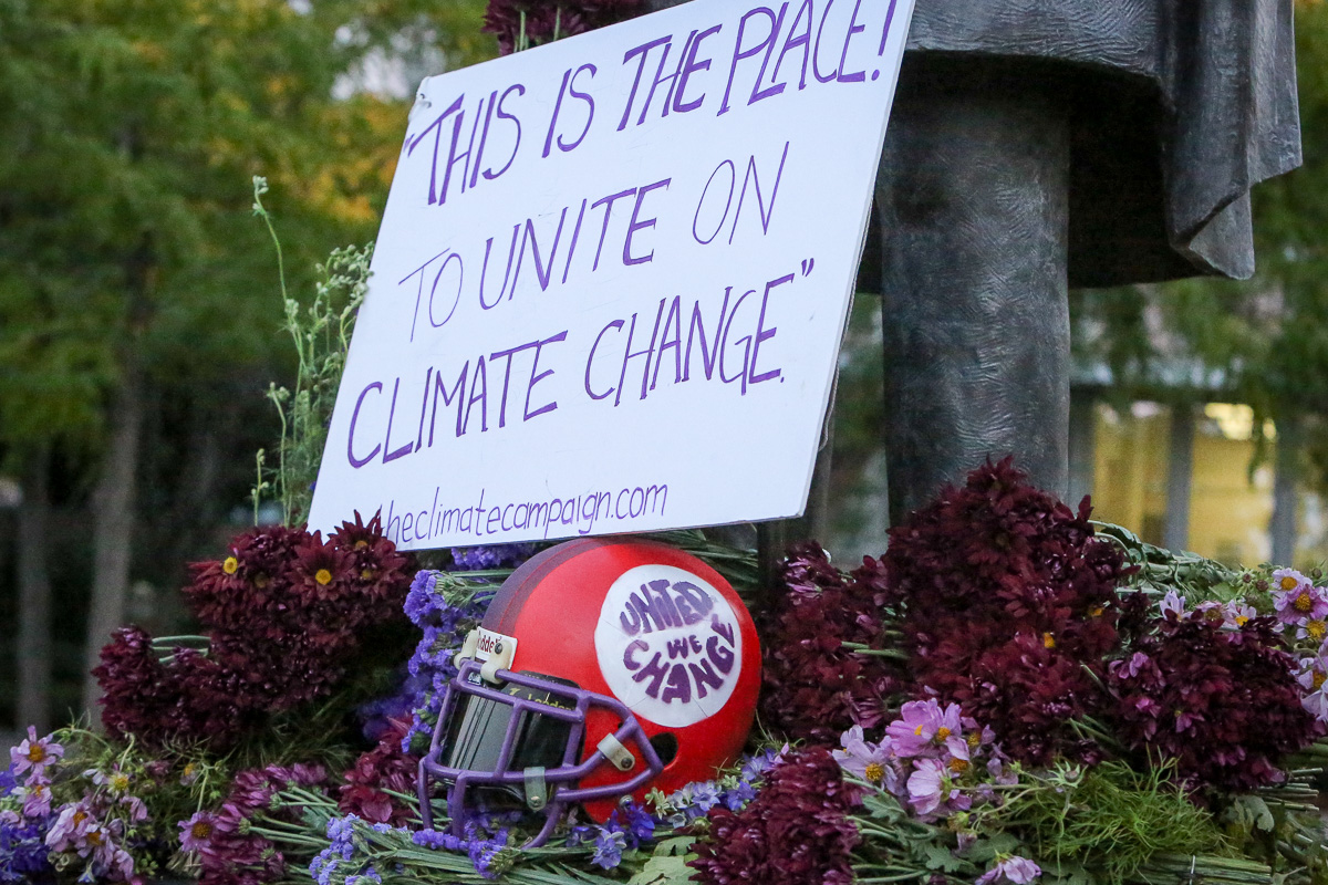 The flowers, helmet and sign at the foot of the Brigham young Statue on the Brigham Young University campus in Provo on Tuesday, Sept. 5, 2017. The Climate Campaign consists of students from Utah and BYU who believe climate change awareness is necessary and can be had by diverse groups. (Photo: Adam Fondren, Deseret News)
