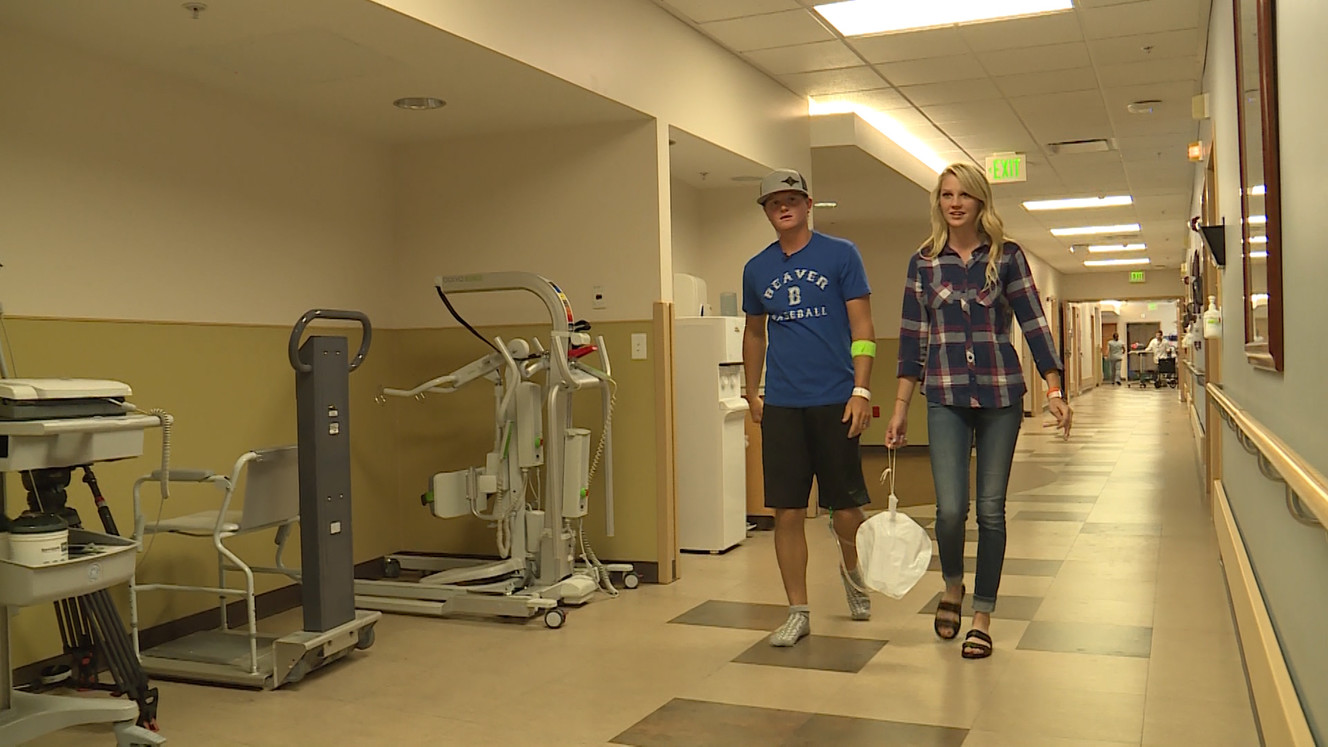 Former Beaver High receiver/safety Payson Fails walks with his wife at Intermountain Medical Center after receiving a kidney transplant from his mother Shanna, Thursday, Sept. 7, 2017 in Salt Lake City. (Photo: Jay Dortzbach, KSL TV)