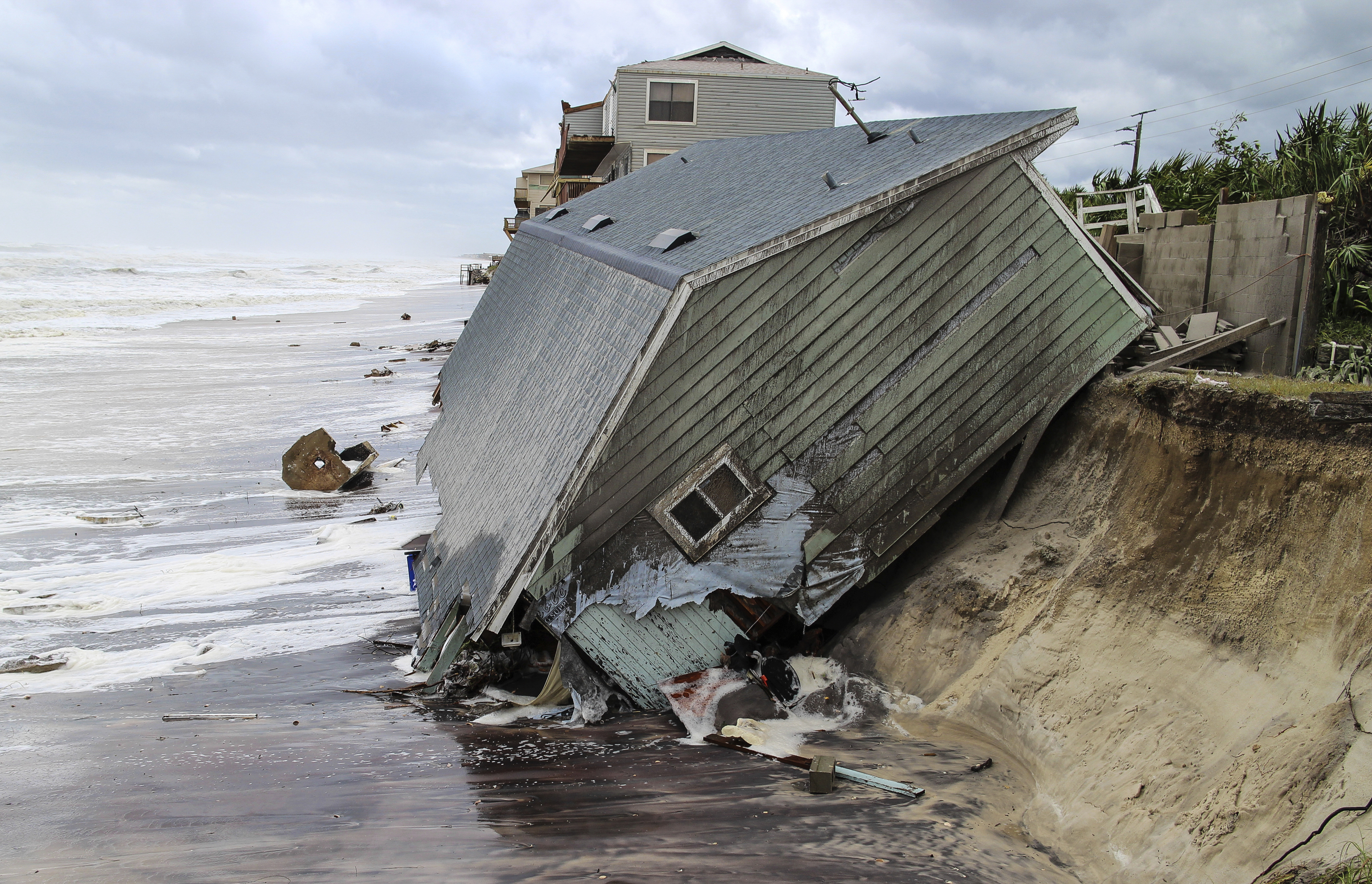 A house slides into the Atlantic Ocean in the aftermath of Hurricane Irma in Ponte Vedra Beach, Fla., Monday, Sept. 11, 2017. (Gary Lloyd McCullough/The Florida Times-Union via AP)