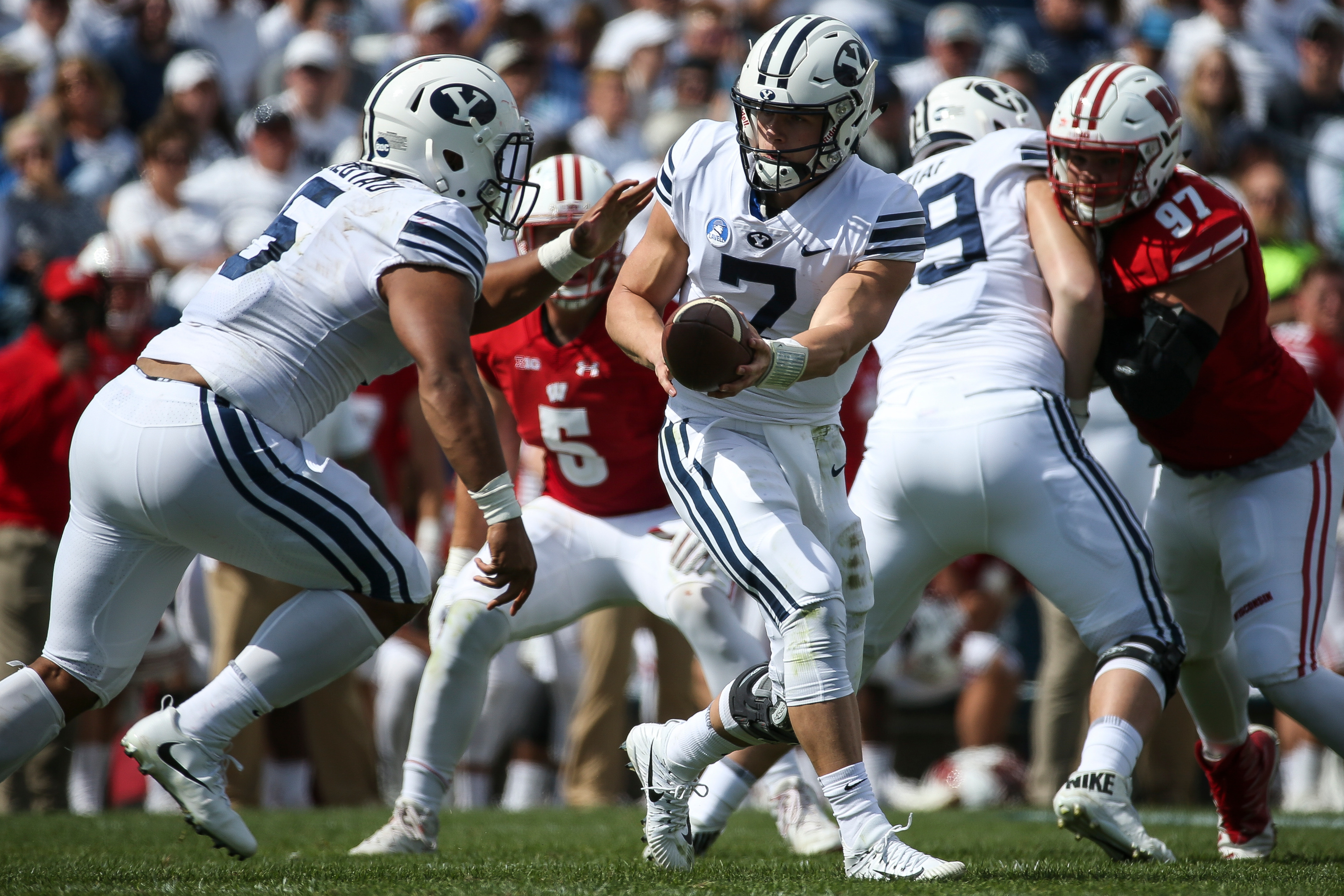 BYU quarterback Beau Hoge (7) hands the ball off to running back Ula Tolutau (5) during the game against the Wisconsin Badgers at LaVell Edwards Stadium in Provo on Saturday, Sept. 16, 2017. (Photo: Spenser Heaps, Deseret News)