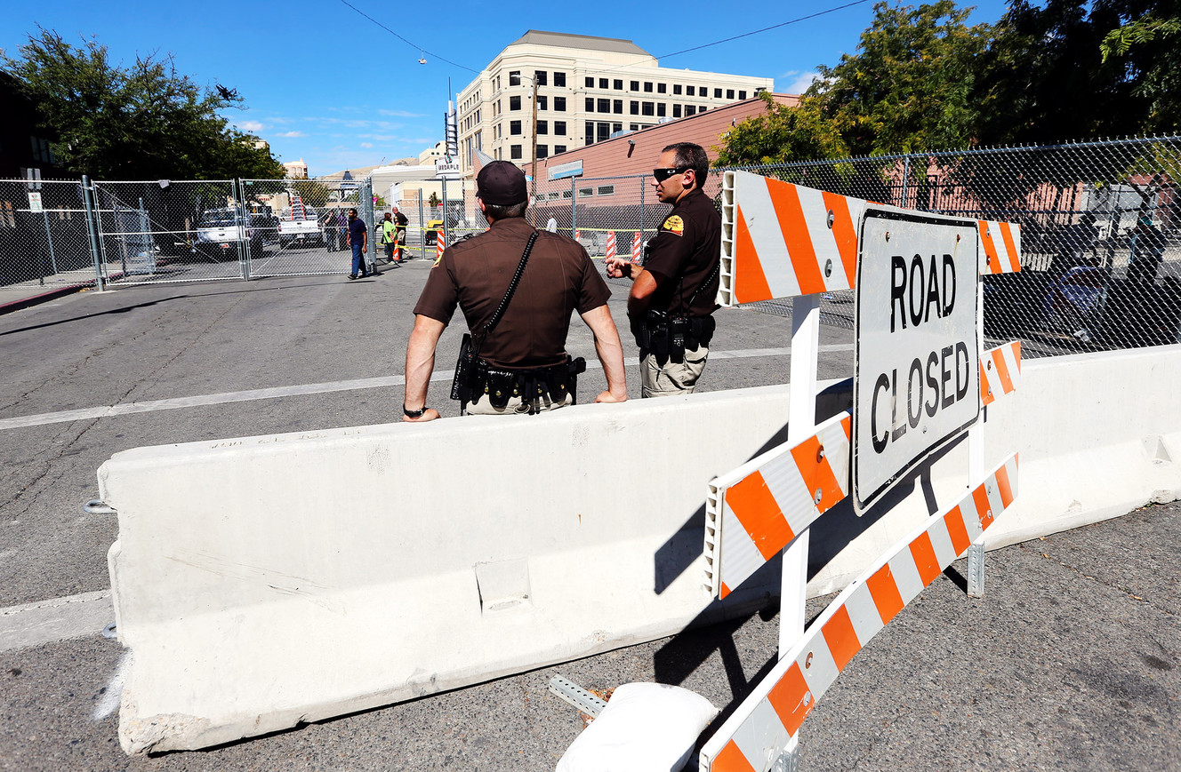 Utah Highway Patrol troopers keep watch as workers install a semipermanent structure on Rio Grande Street in Salt Lake City on Wednesday, Sept. 20, 2017. (Photo: Scott G Winterton, Deseret News)