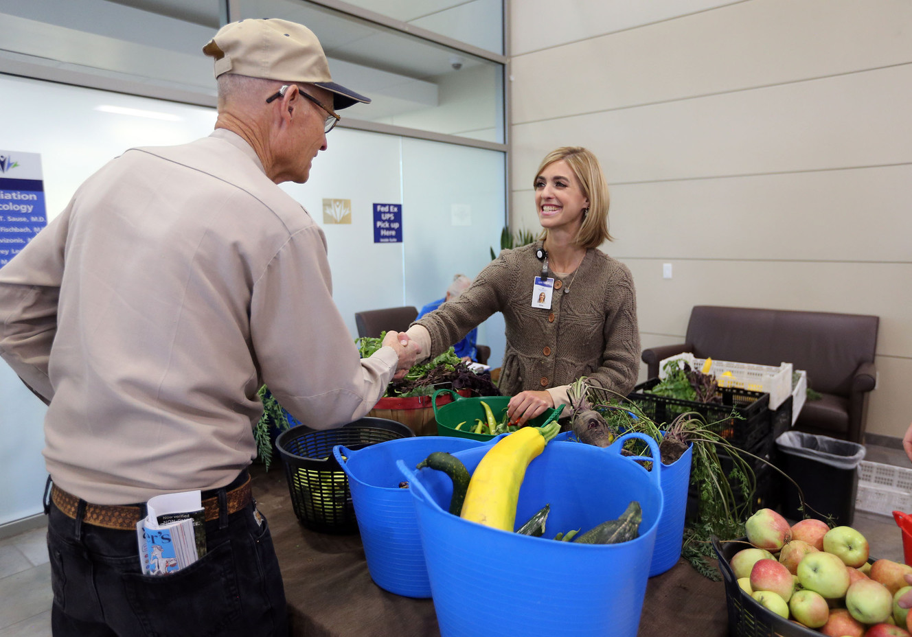 Ross Workman shakes hands with Elisa Soulier, manager of the Intermountain Medical Center's LiVe Well oncology program, after picking up some fruit and vegetables at the free farmers market for cancer patients at the Intermountain Medical Center Cancer Center in Murray on Thursday, Sept. 21, 2017. The produce is provided by the Green Urban Lunch Box. (Photo: Kristin Murphy, Deseret News)