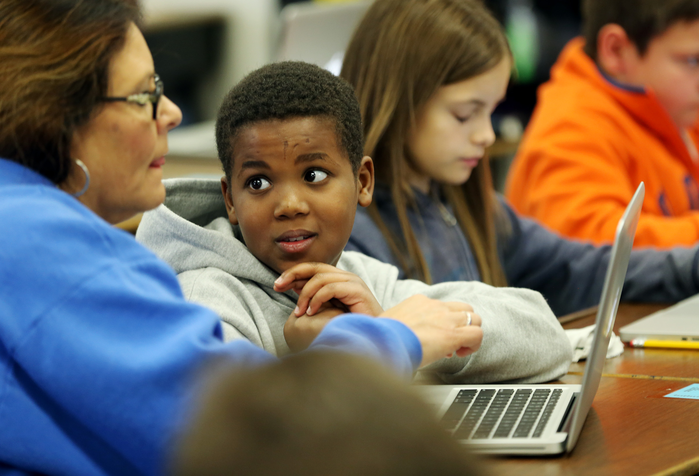 Samir Hassan looks up at his teacher Lisa Hubbard as they work on their computers at East Midvale Elementary on Monday, Sept. 25, 2017. (Photo: Scott G. Winterton, KSL)