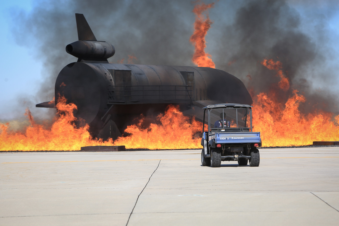 A Salt Lake City firefighter watches as an aircraft burns during an emergency exercise at the Salt Lake City International Airport. (Photo: Adam Fondren, KSL)