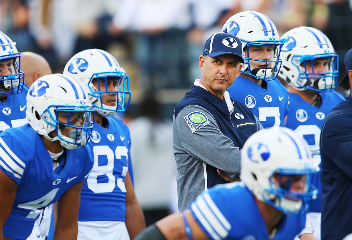 Former BYU quarterback Ty Detmer looks on during warmups as BYU and USU prepare to play at Maverik Stadium in Logan Utah on Friday, Sept. 29, 2017. After two seasons as offensive coordinator, BYU fired the 1990 Heisman Trophy winner at the close of a 4-9 season. He went 13-13 in his return to BYU as an assistant coach. (Photo: Scott G Winterton, Deseret News)