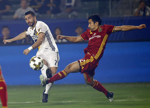 Los Angeles Galaxy midfielder Romain Alessandrini, left, shoots over Real Salt Lake defender Tony Beltran during the first half of an MLS soccer game in Carson, Calif., Saturday, Sept. 30, 2017. (Photo: Alex Gallardo, AP)