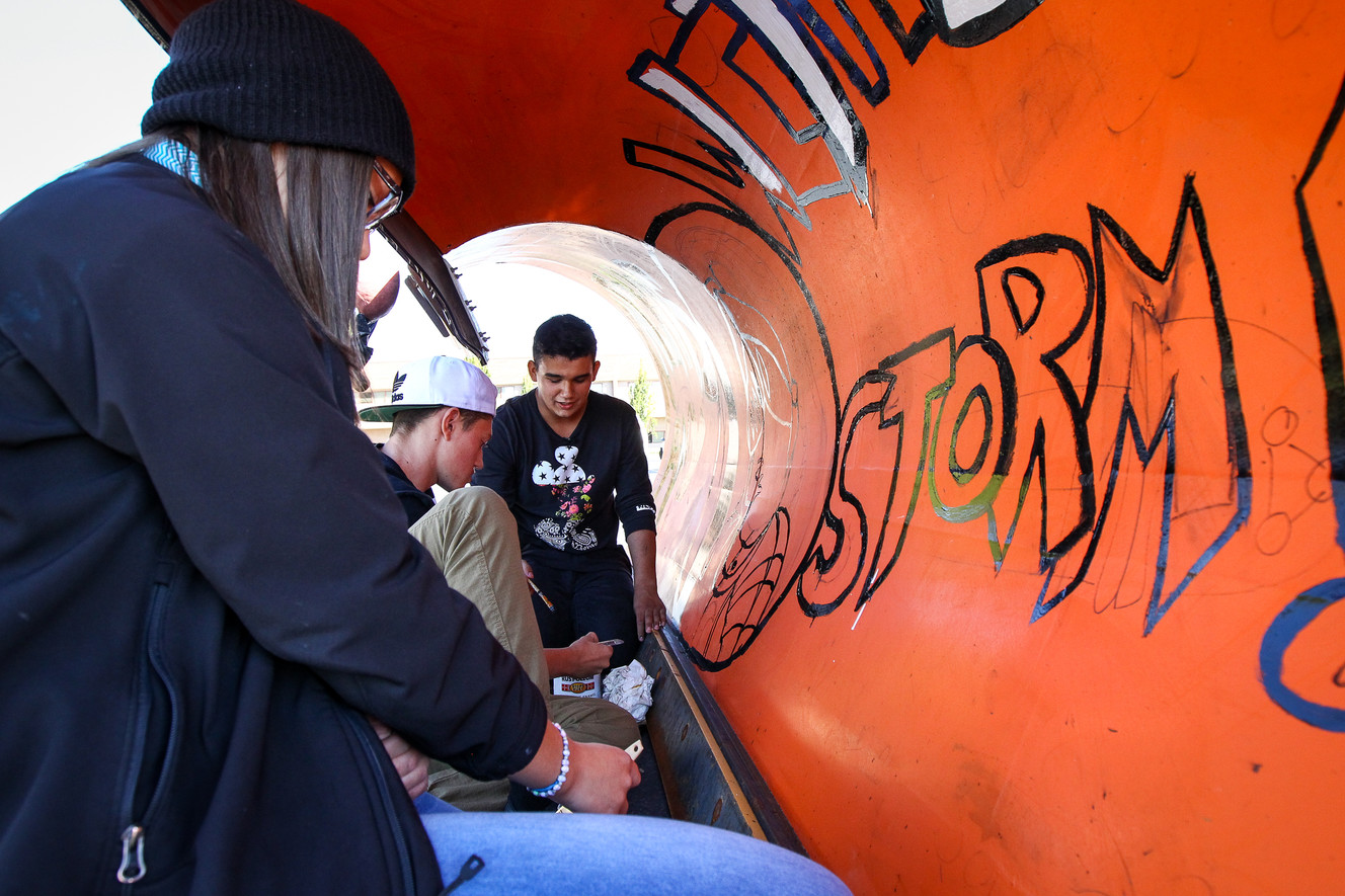 Sirese Loving, Trey Bielaczyc and Michael Rivera paint a Utah Department of Transportation snowplow at Northridge High School in Layton on Thursday, Oct. 5, 2017. This plow will be used along I-15 in Davis County this winter. (Photo: Adam Fondren, KSL)