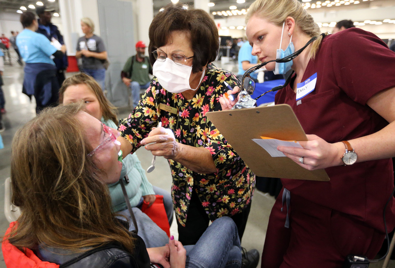 Arya Cunningham has her teeth looked at by dental hygienist Ellen Christensen and student dental student Emily Worth during Salt Lake City’s first Project Homeless Connect at the Salt Palace Convention Center in Salt Lake City on Friday, Oct. 6, 2017. (Photo: Kristin Murphy, KSL)