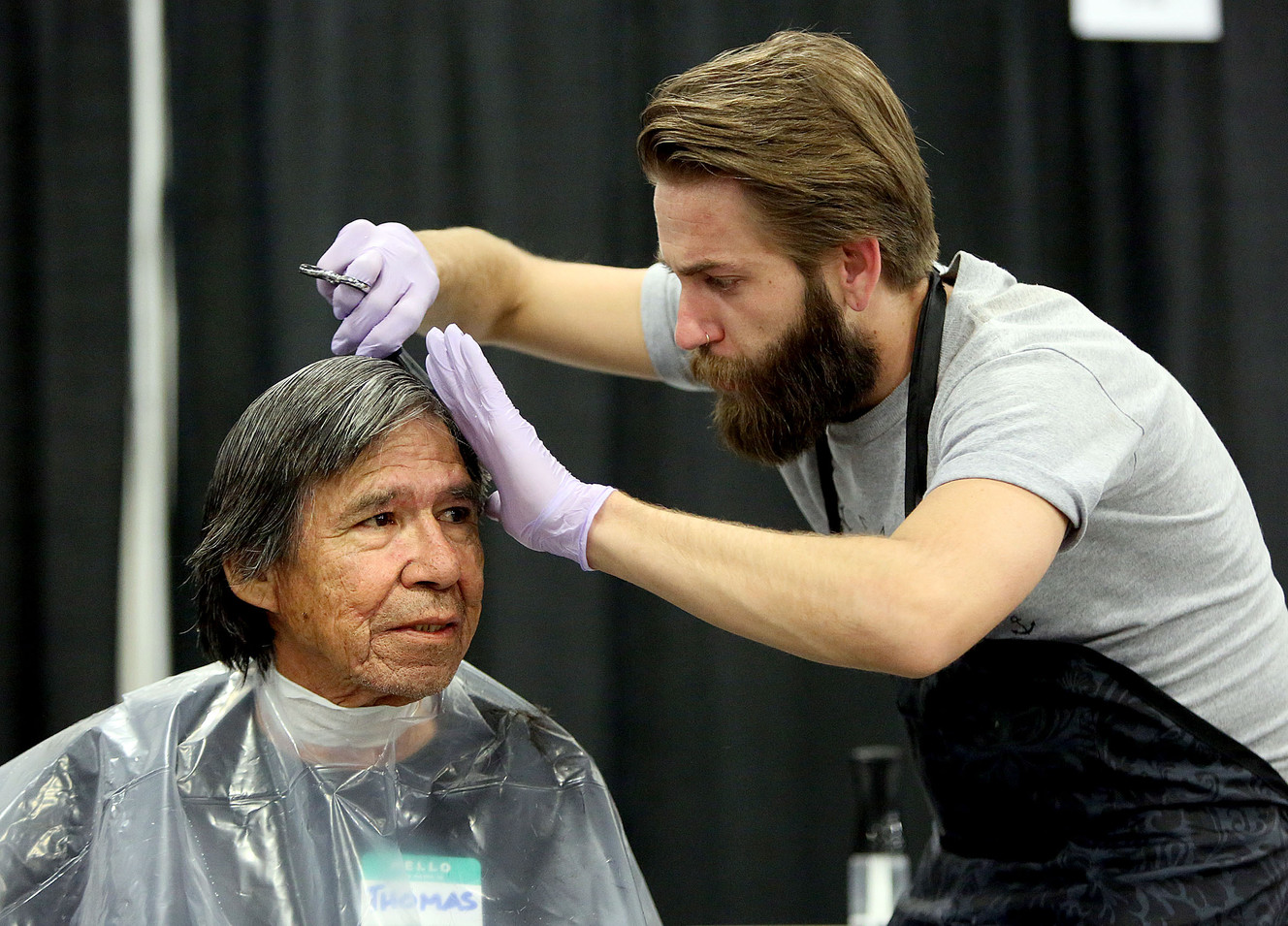 Thomas Redpipe gets his hair cut by Casey Kinnaman, from City Barbers, at Salt Lake City’s first Project Homeless Connect at the Salt Palace Convention Center in Salt Lake City on Friday, Oct. 6, 2017. (Photo: Kristin Murphy, KSL)